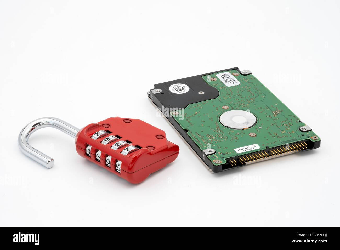 Padlock next to hard disk drive representing data protection and security Stock Photo