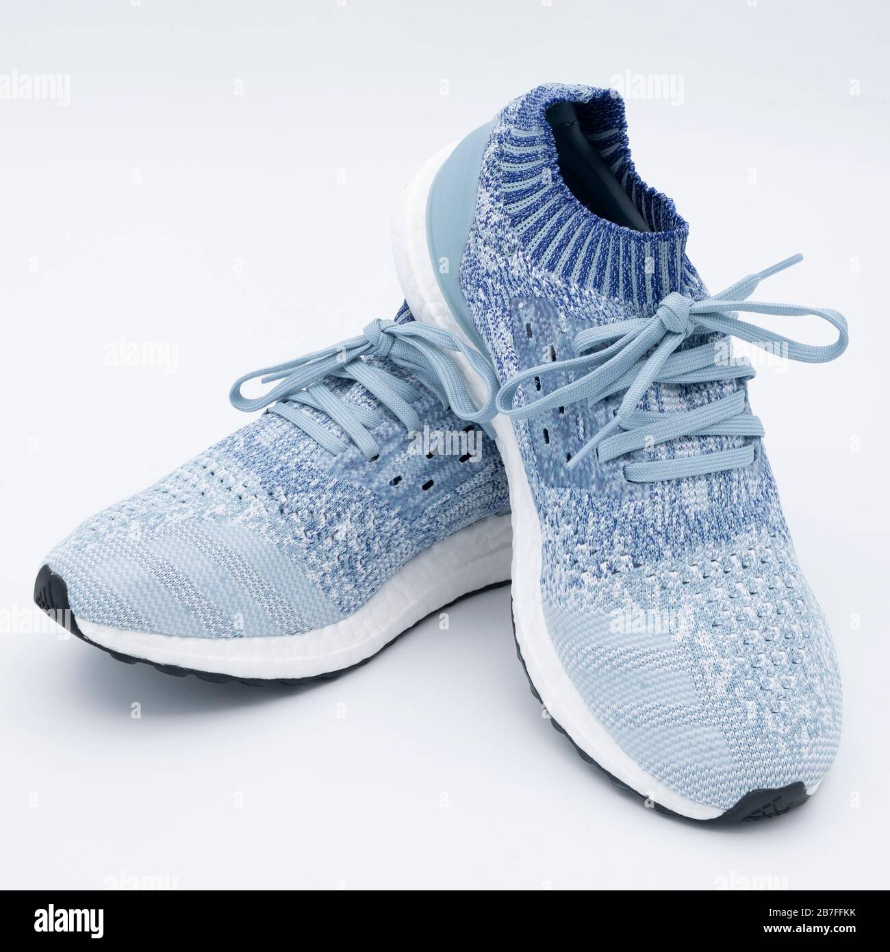 Pair of blue uncaged Adidas Ultraboost running shoes cutout isolated on  white background Stock Photo - Alamy