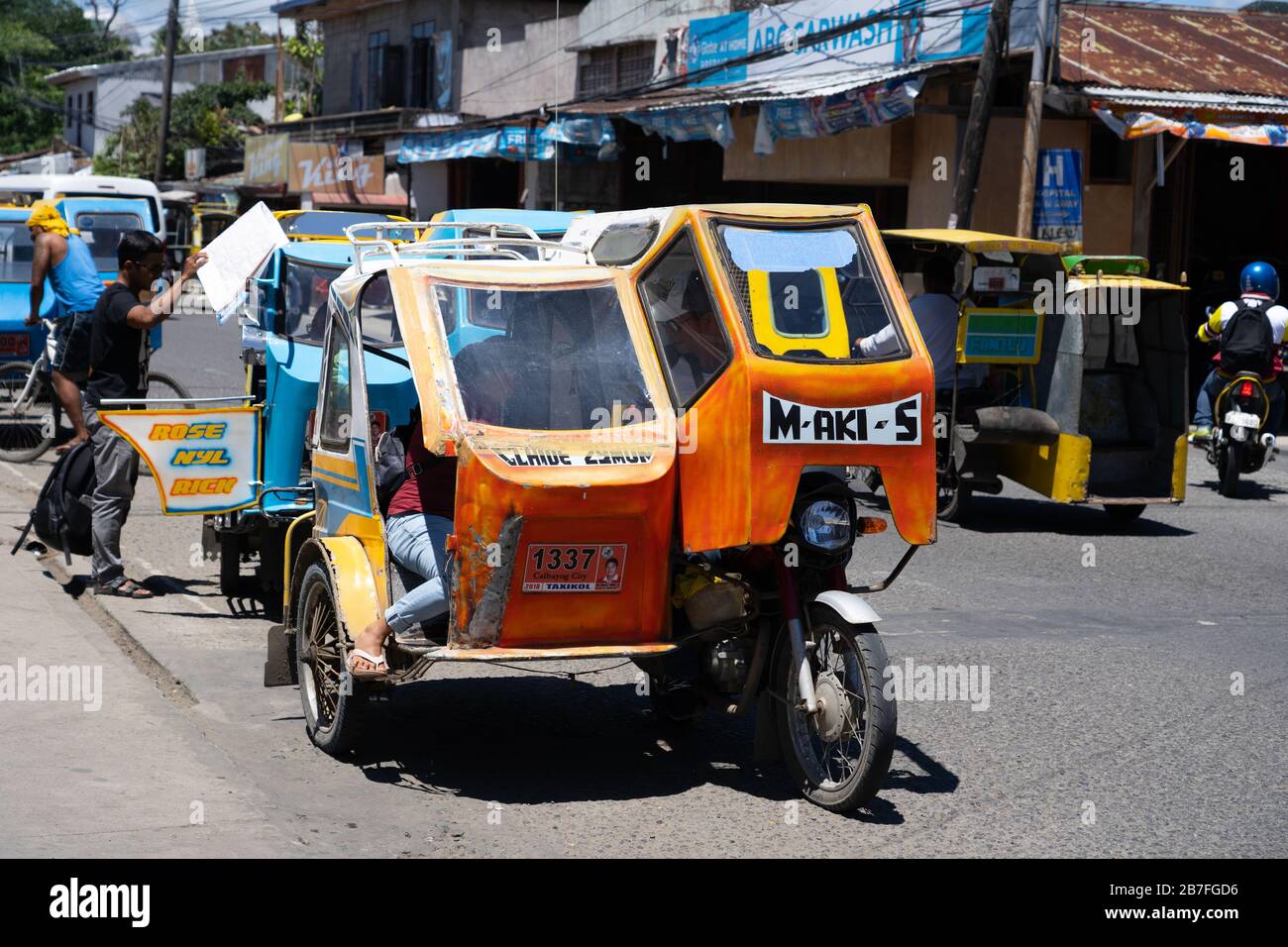 Traditional small tricycle public transportation vehicles used in the Philippines.Styles can vary in different provinces these particular vehicles cap Stock Photo