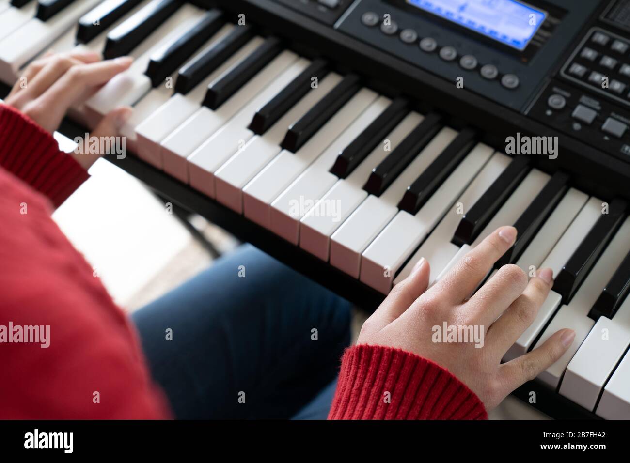 Little girl hand playing piano keyboard Stock Photo Alamy