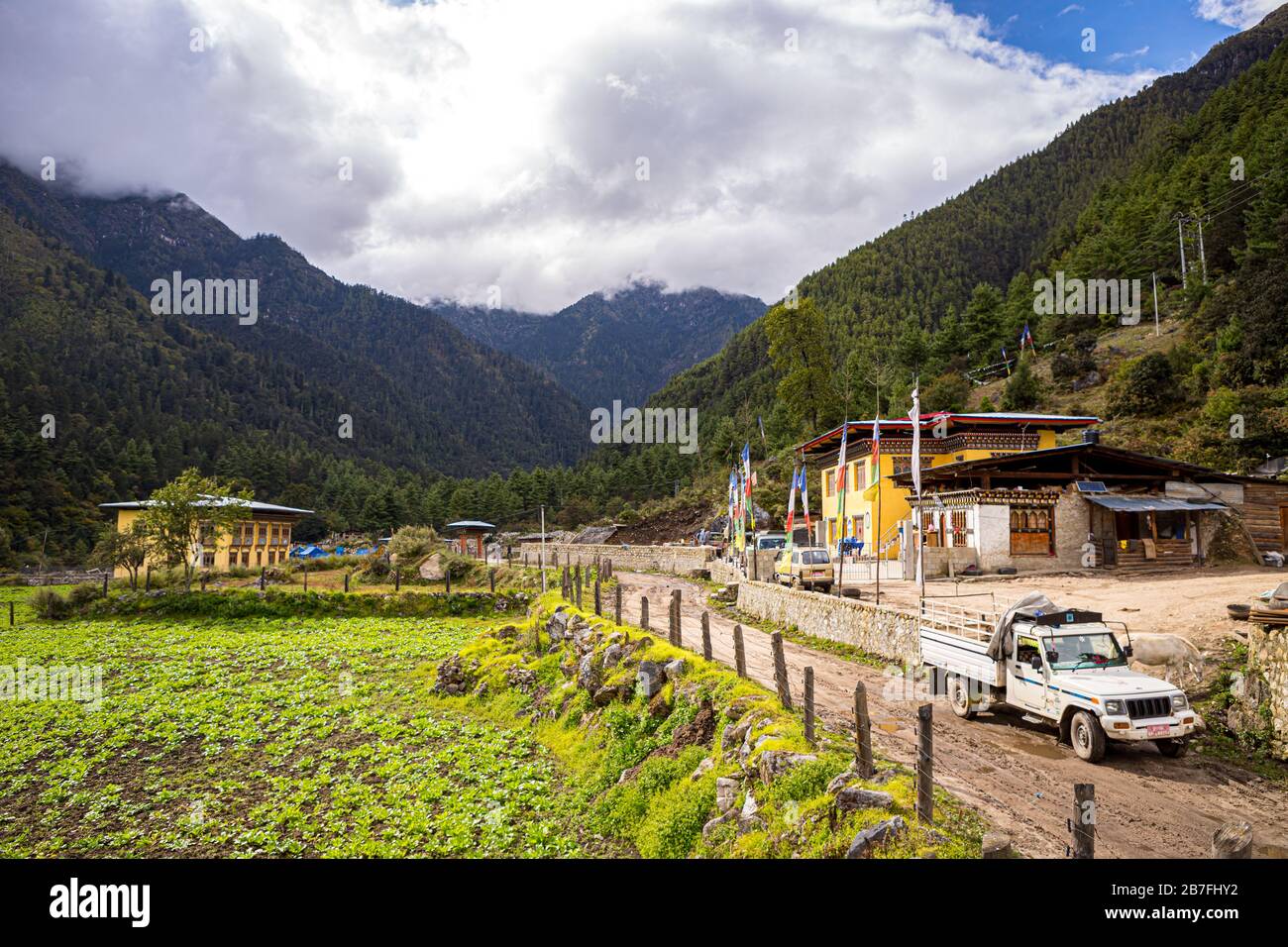 A pickup truck at the end of the dirt road near a trailhead in the small village of Shana, Bhutan Stock Photo