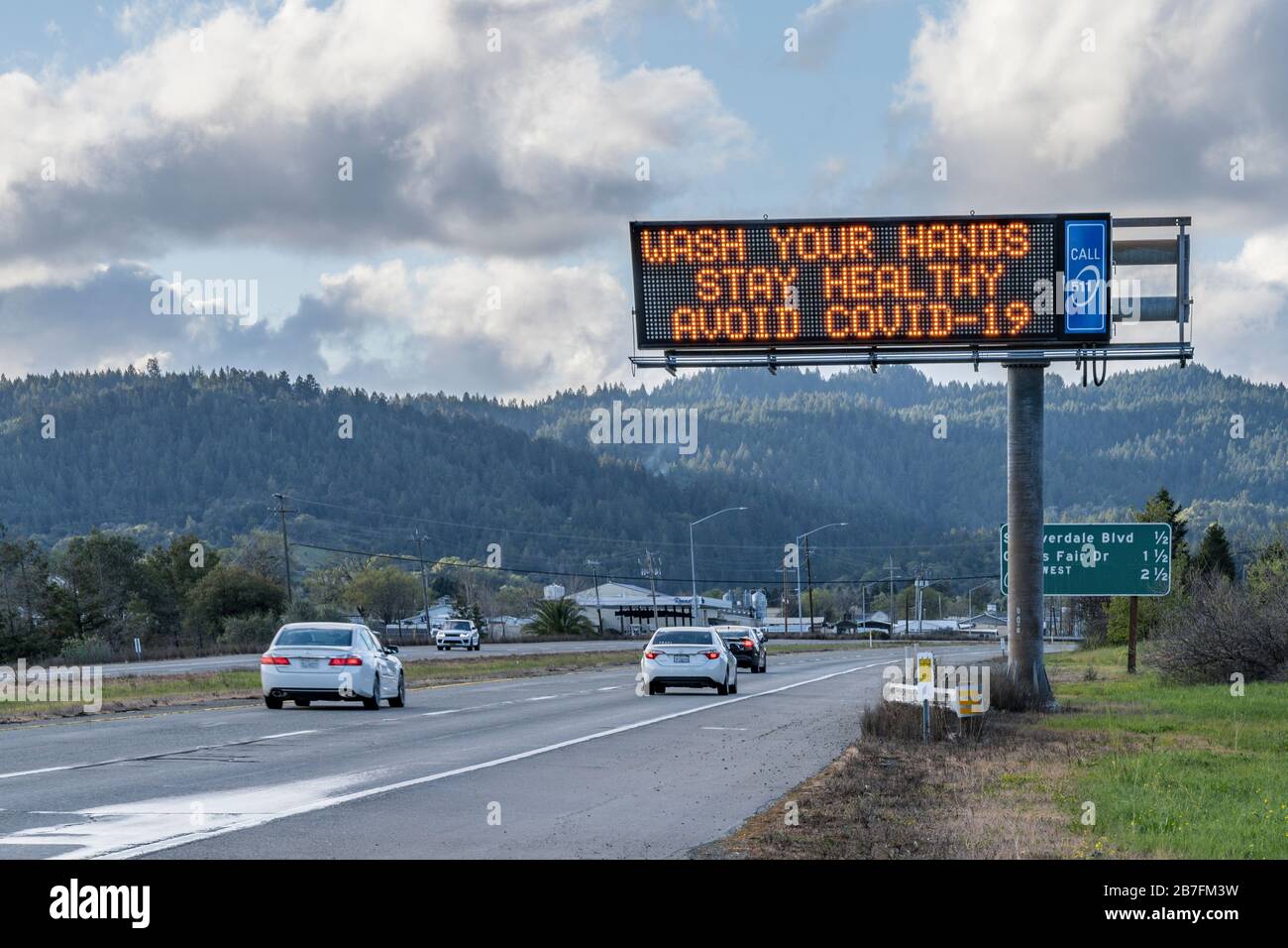 Highway message board promoting safety protocols for avoiding COVID-19 Coronavirus. Stock Photo