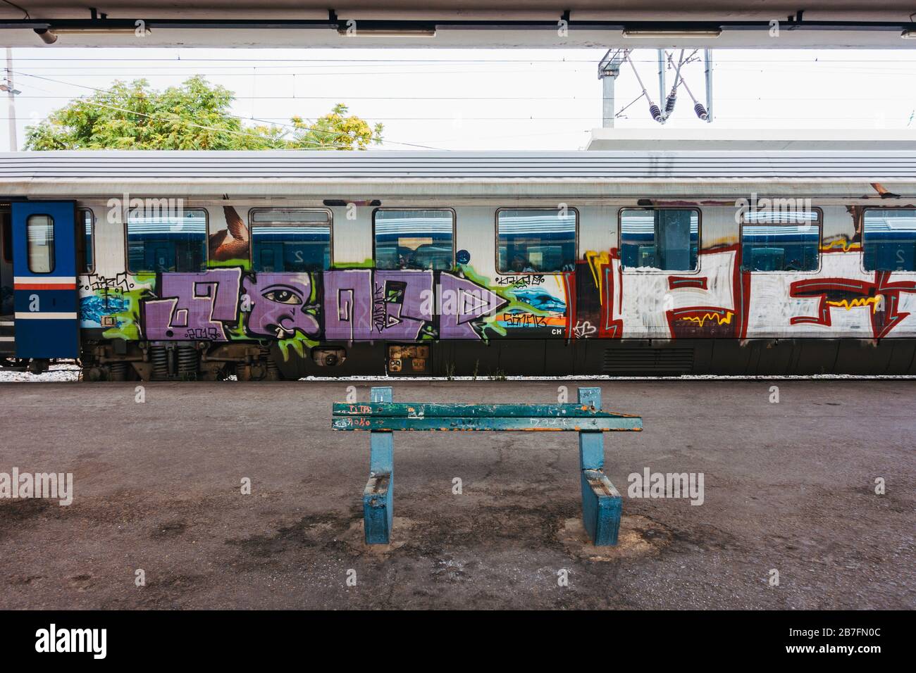 Passenger train carriages covered in graffiti at Thessaloniki Station, Greece, on the Athens to Thessaloniki high-speed train line Stock Photo