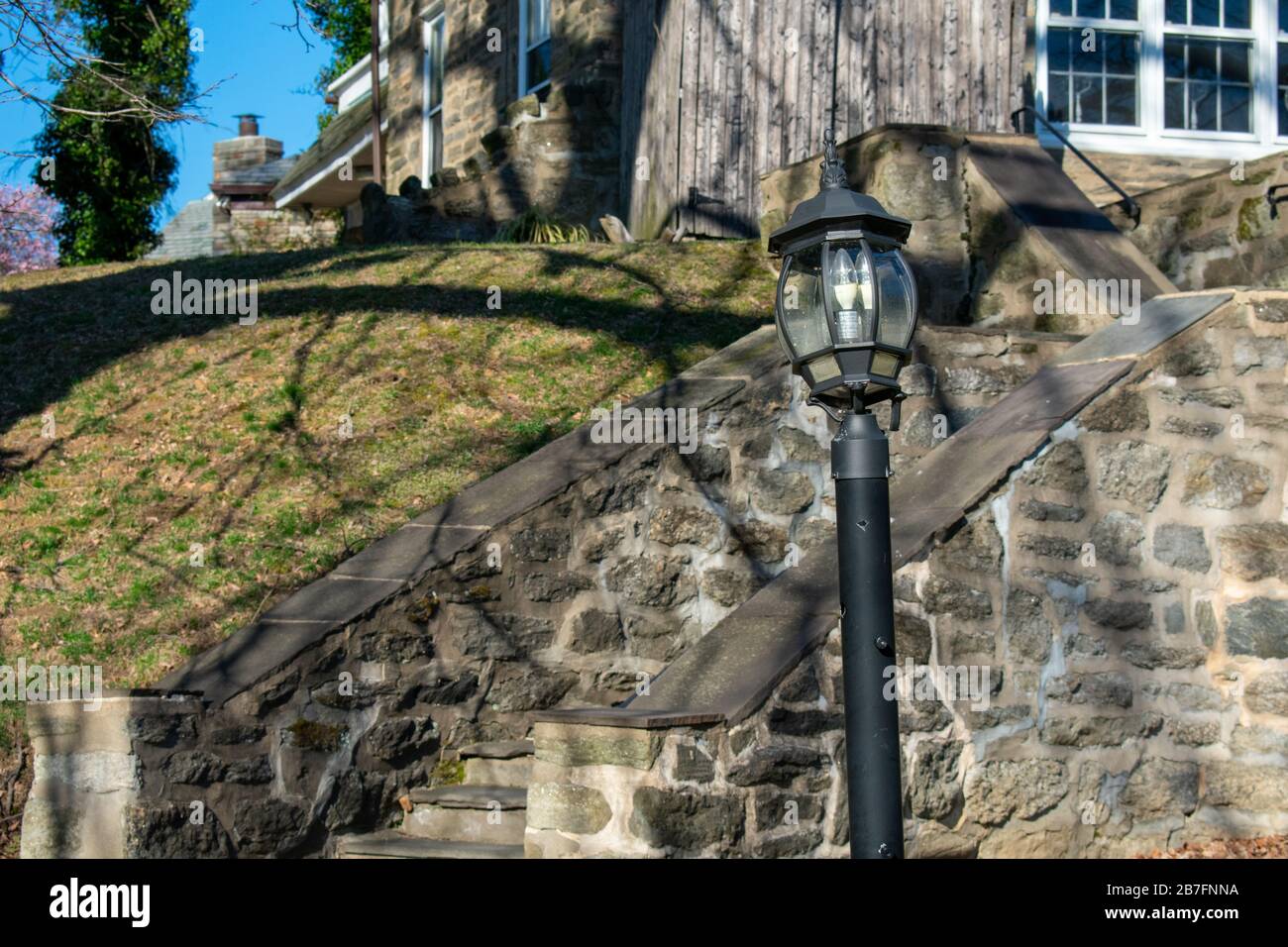 A Lightpost with a Stone Pathway Behind It Stock Photo