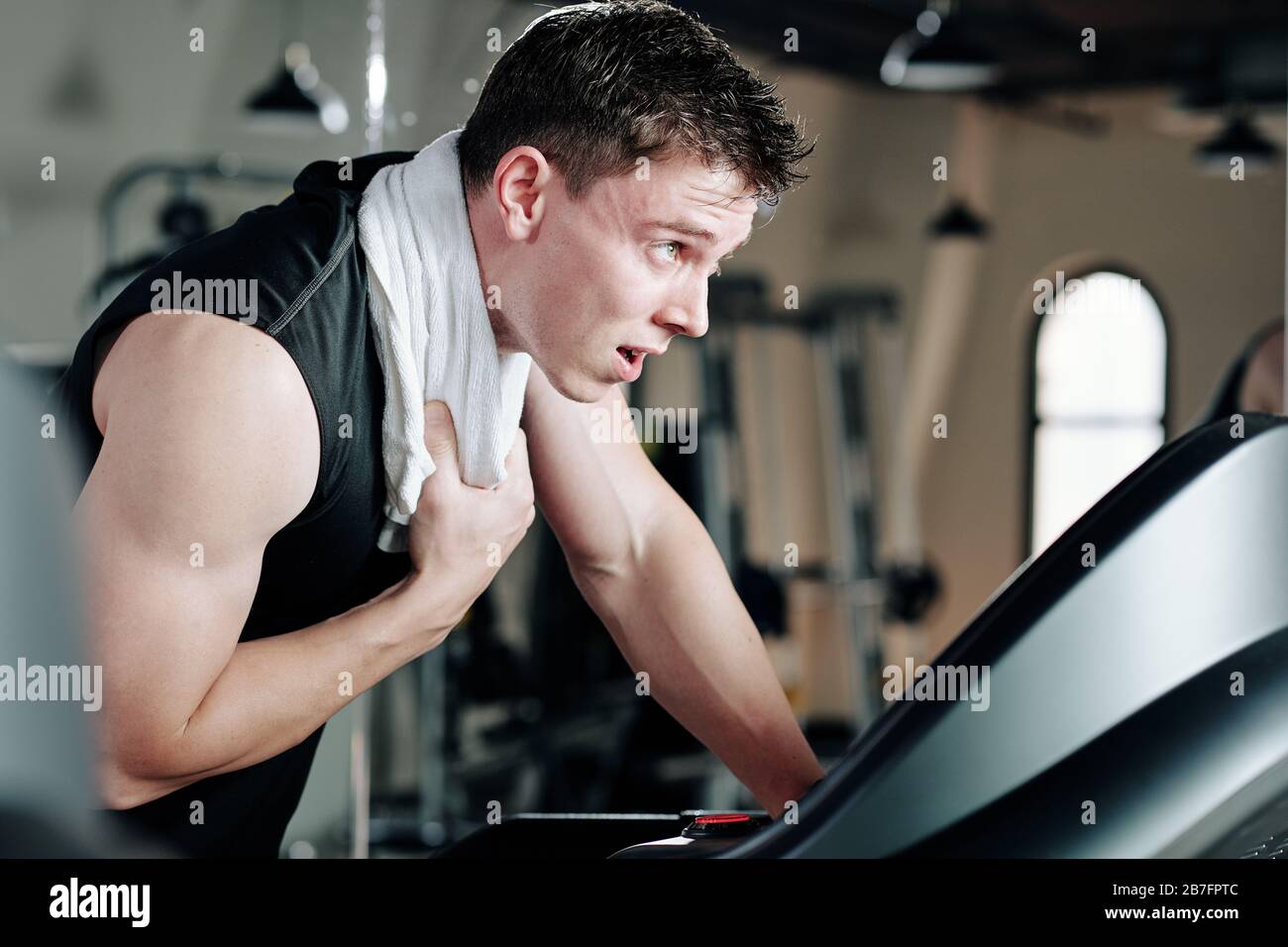 Sweaty after great work out. Handsome young men in sportswear whipping  sweat with his towel and holding water bottle while sitting at gym 13487667  Stock Photo at Vecteezy
