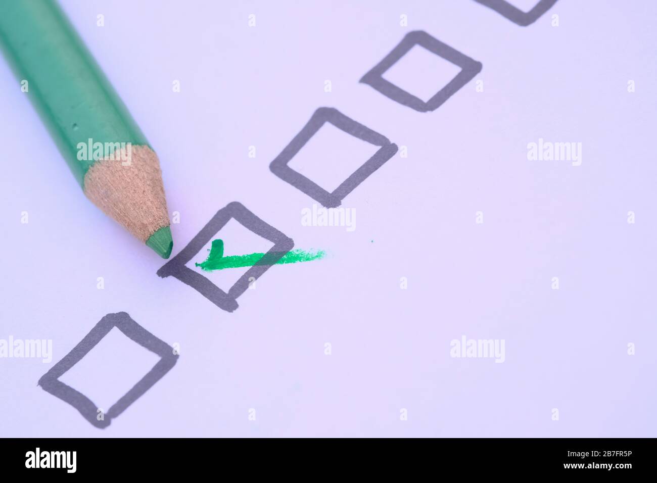 check mark on paper with green pen Stock Photo Alamy