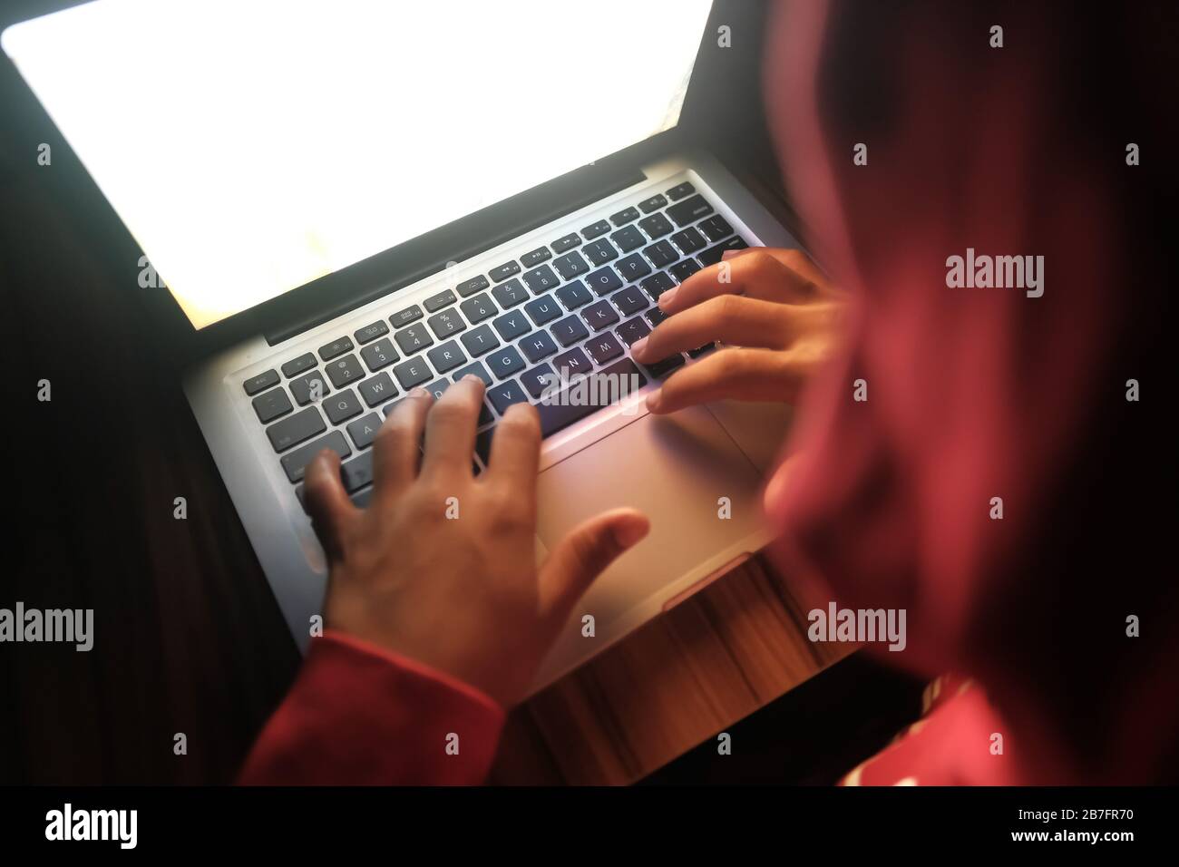 hooded hacker stealing data from laptop  Stock Photo