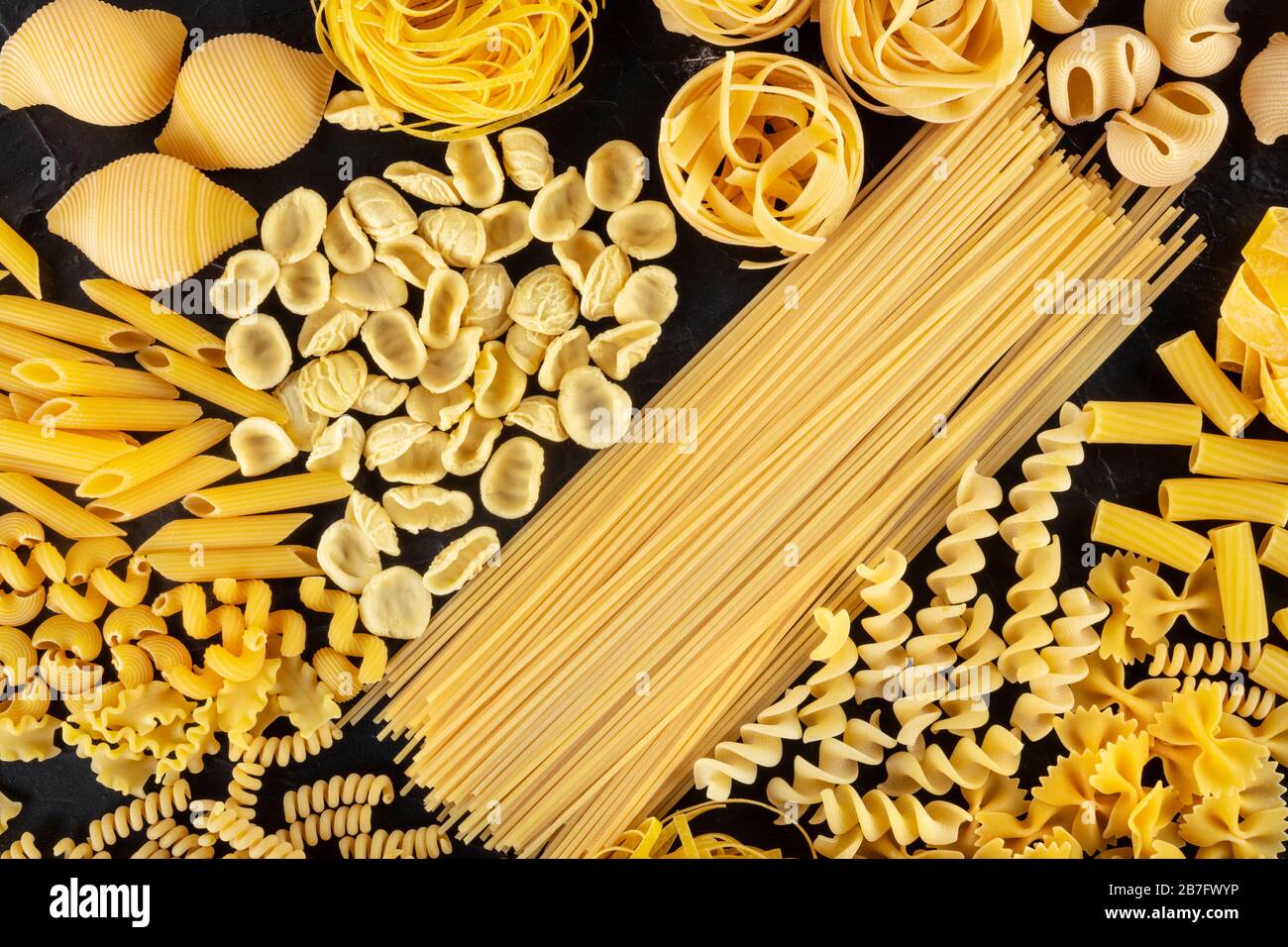 Italian pasta variety, a flat lay of various pasta types, shot from above  on a black background Stock Photo - Alamy