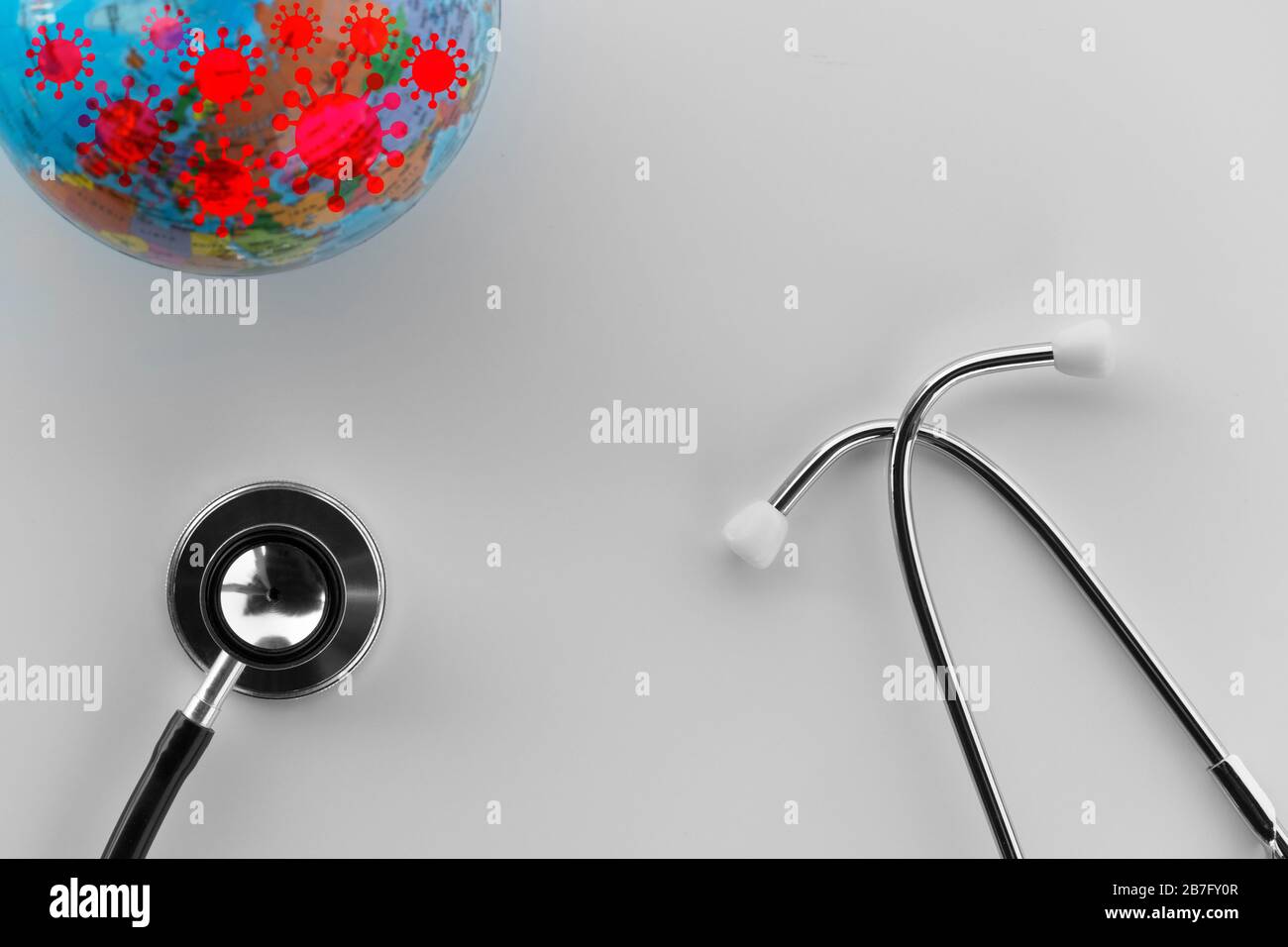 stethoscope for medical health doctor diagnosis  with blue world model and red coronavirus or covid-19 pandemic disease concept white background Stock Photo