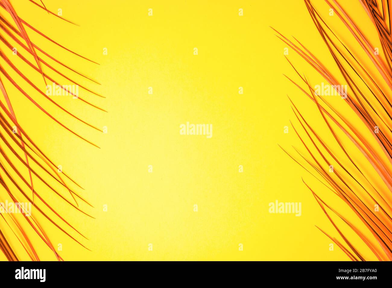 Painted tropical palm leaves on bright yellow background with copy ...