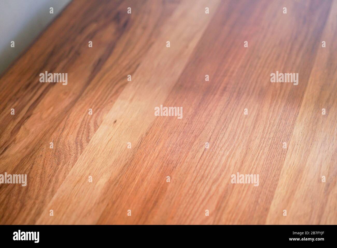 Closeup of a plywood table against a wall under the lights interior