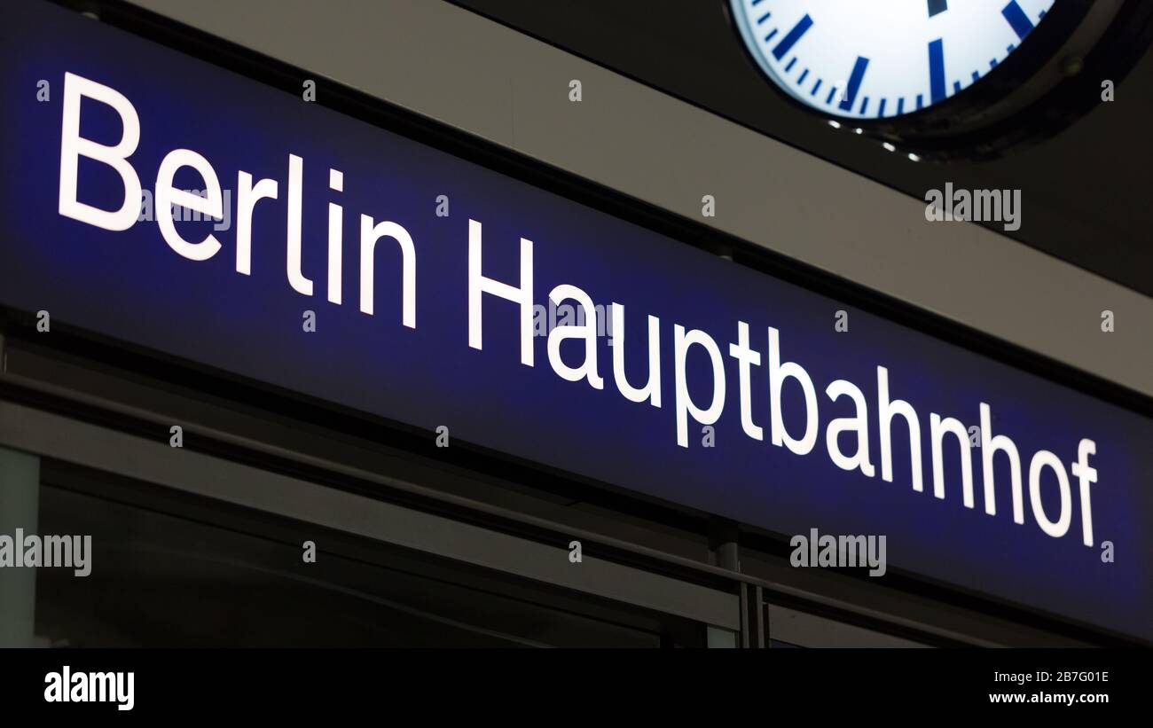 Close up of sign Berlin Hauptbahnhof (main / central station). Parts of a watch at the top right corner. Symbol for travel, sightseeing, tourism. Stock Photo