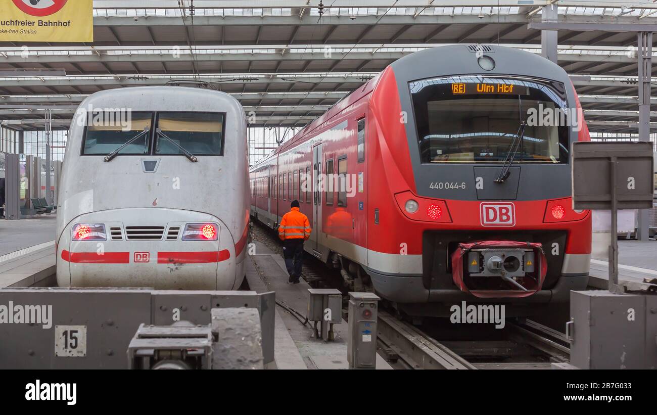 Rear view of two trains at Munich central / main station: An Intercity Express (ICE, second gen,) and a regional (RE) train of Deutsche Bahn (DB). Stock Photo