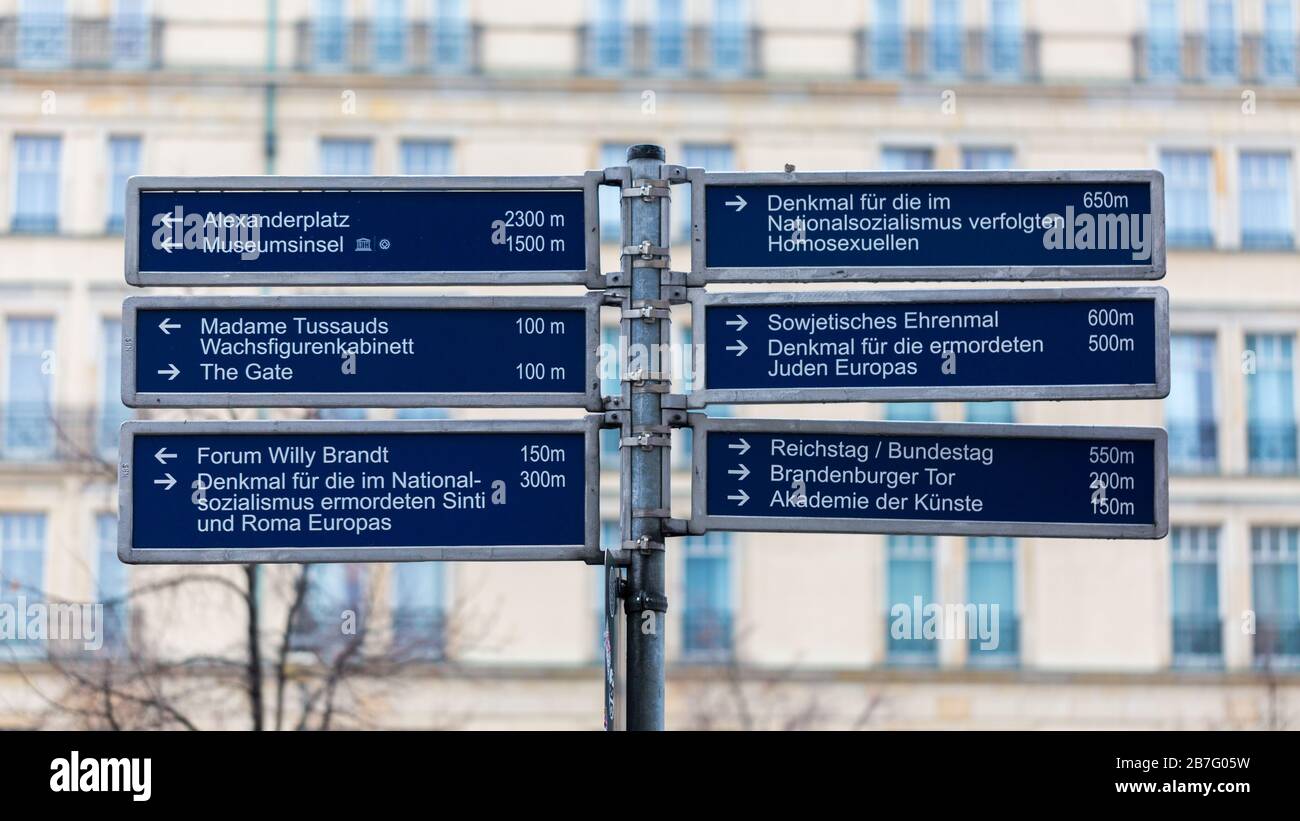 Signpost listing numerous tourist attractions / travel destinations of the german capital. Incl. popluar sightseeing spots like Brandenburg Gate. Stock Photo