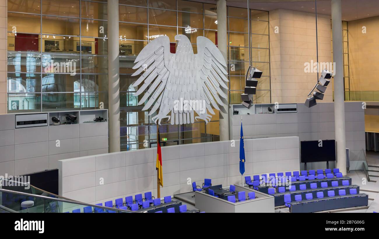 View on interior of the empty plenary hall of the German Federal Parliament (Deutscher Bundestag). In the middle the german coat of arms (Bundesadler) Stock Photo
