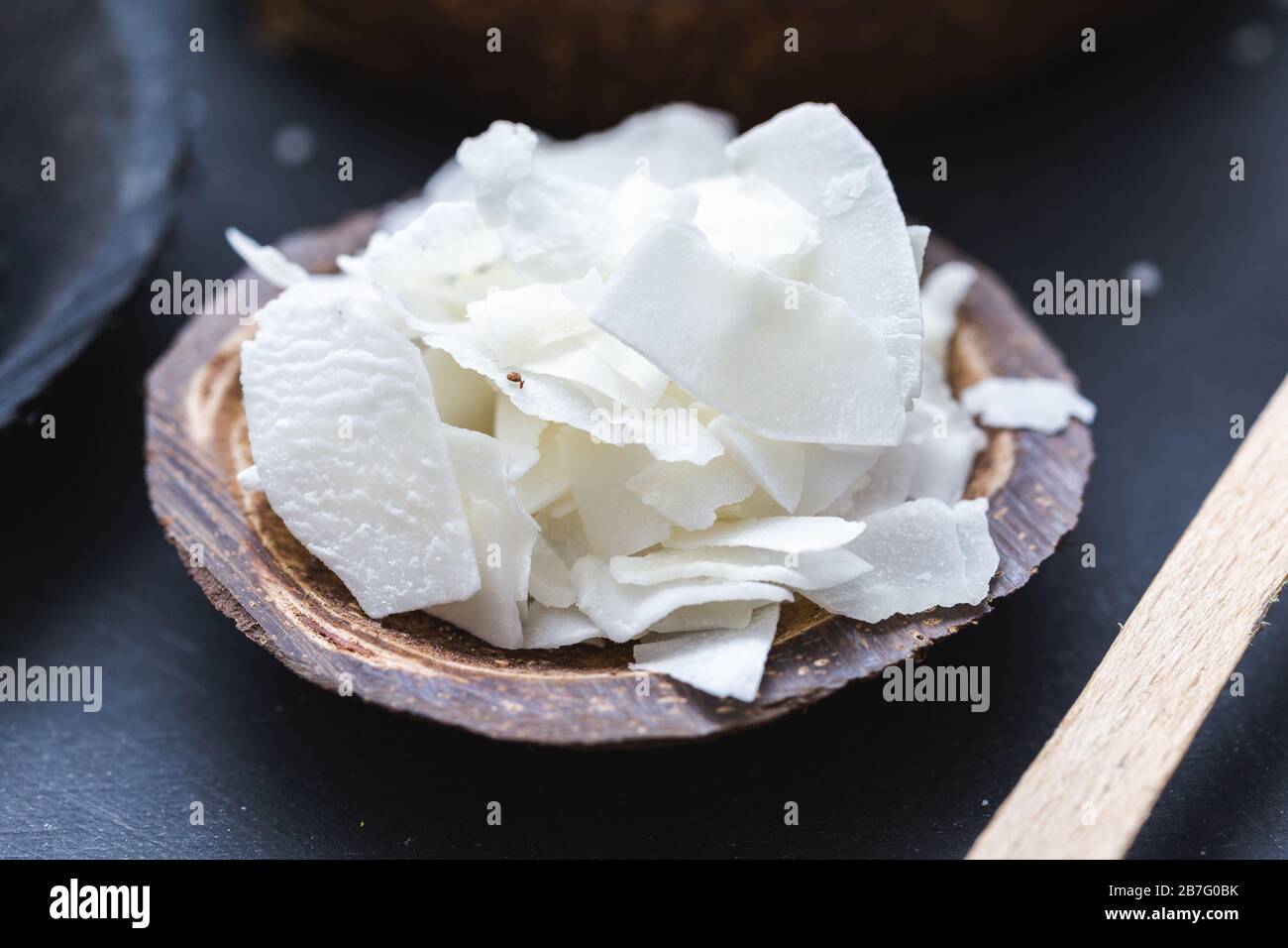Closeup shot of coconut chunks in a coconut shell saucer Stock Photo