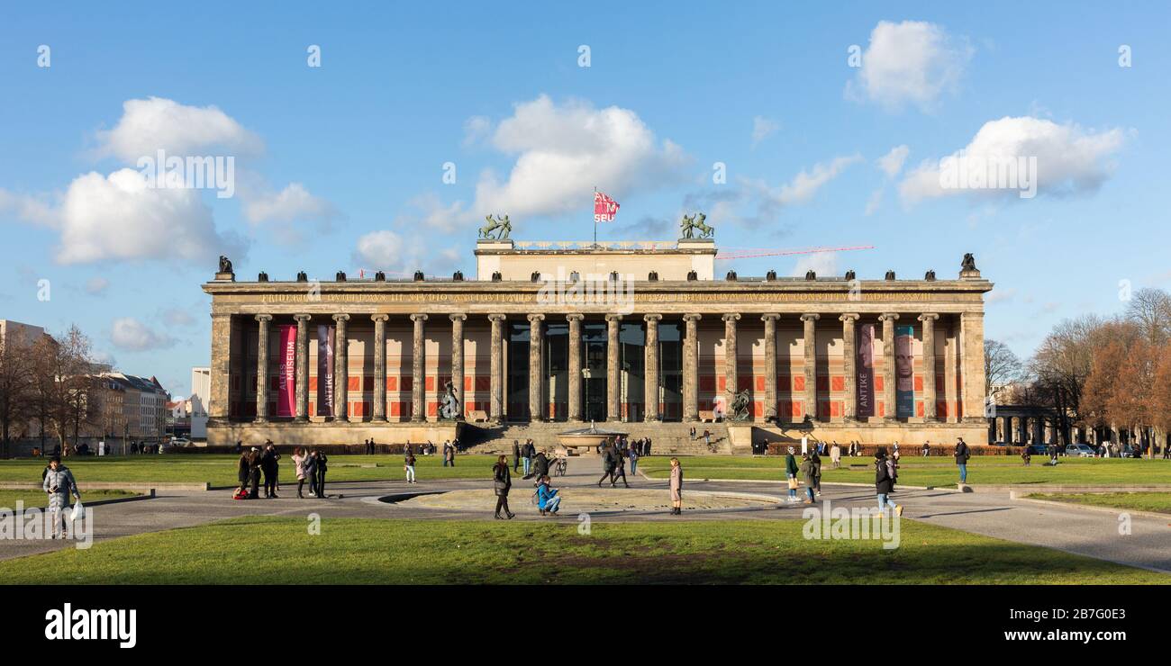 Panorama view of the so-called Altes Museum (Old Museum) with fleecy clouds and blue sky. Tourists walking by. Neoclassical architecture, UNESCO site. Stock Photo