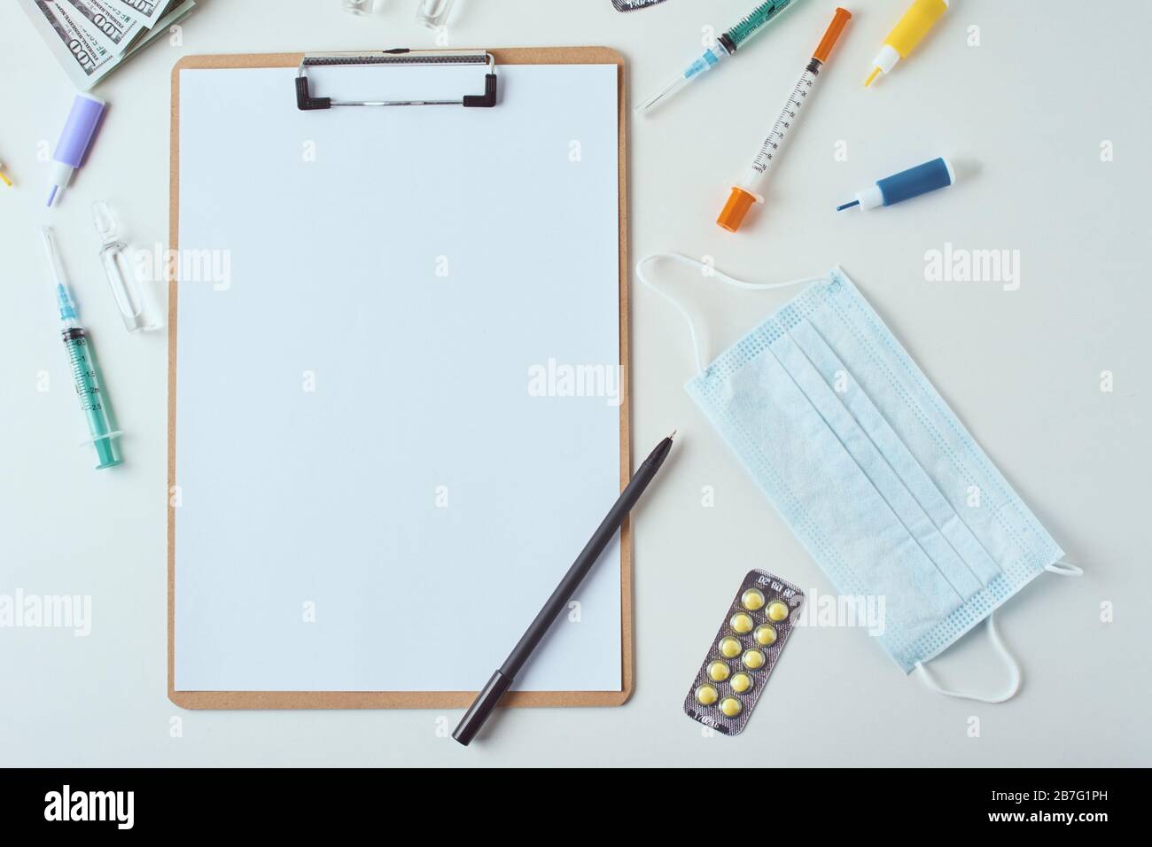 Top view of medical items and empty paper blank sheet on white ...