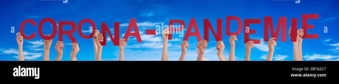 People Hands Holding Word Pandemie Means Corona Pandemic, Blue Sky Stock Photo