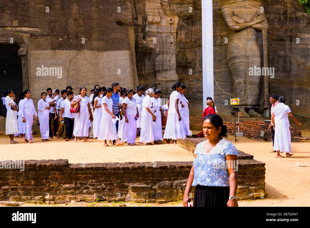 Sri Lanka Ceylon Cultural Triangle Anuradhapura Polonnaruwa Gal Vihara   Buddhist shrine local worshippers walking standing Buddha Stock Photo