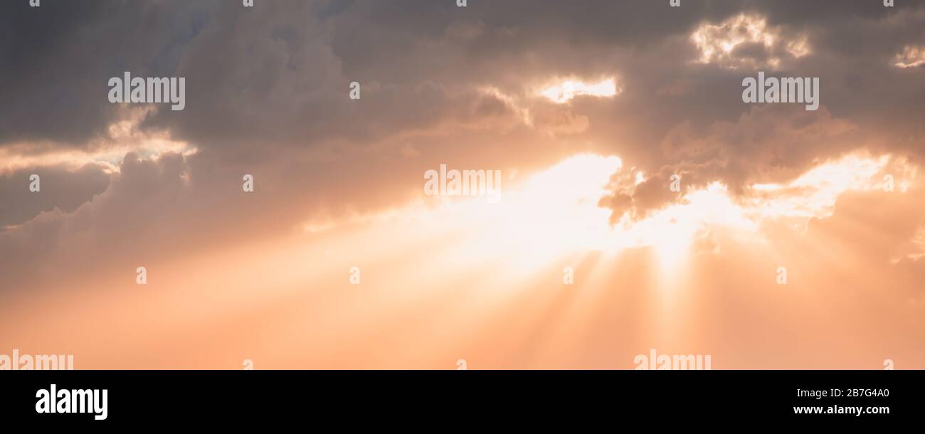 Natural panoramic photo background with sunlight in cloudy evening sky Stock Photo