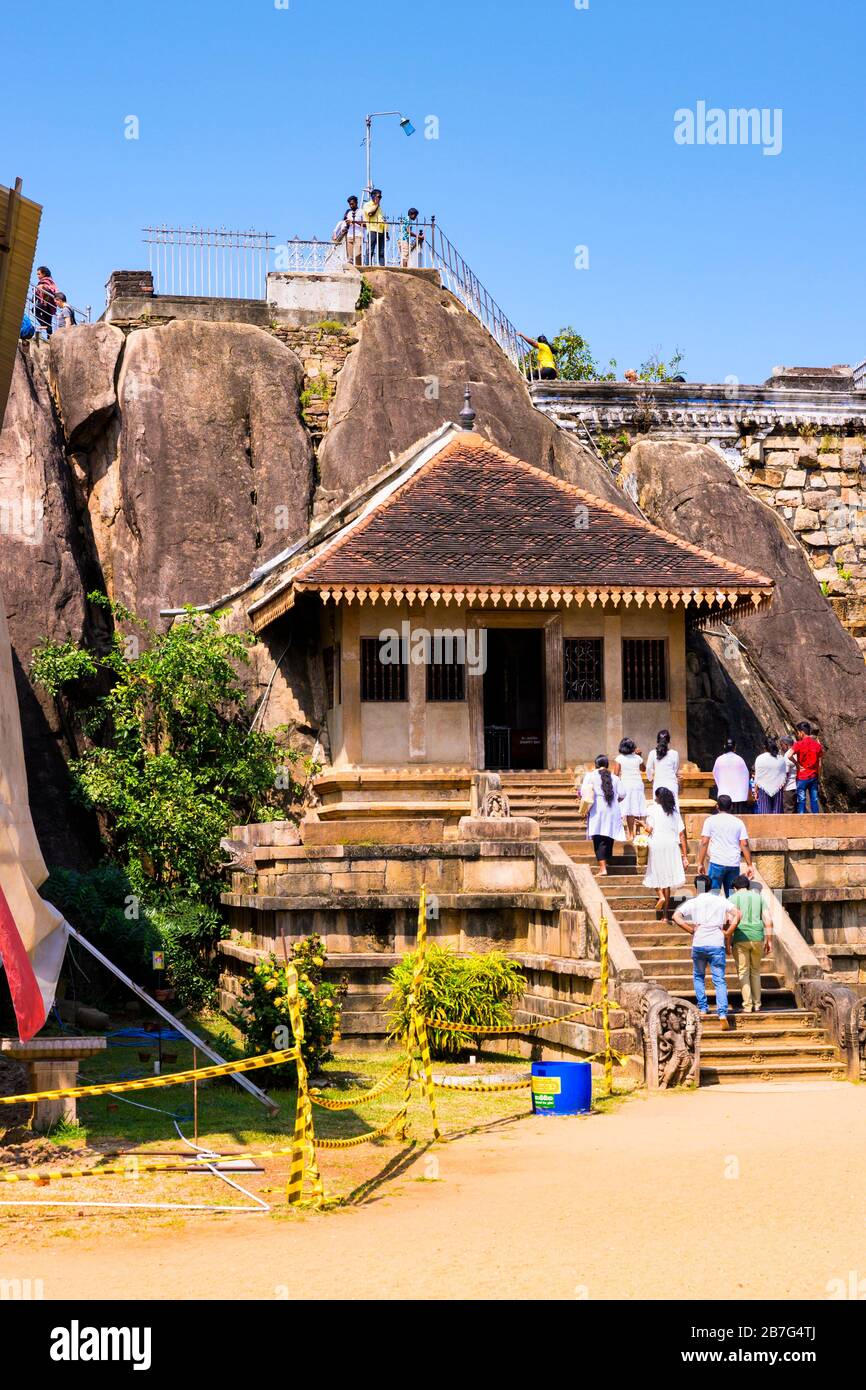 Sri Lanka Anuradhapura Isurumuni Rock Temple Monastery 3 BC King Devanampiya Tissa sacred shrine entrance steps stairs Gneiss Boulder plastic tape Stock Photo