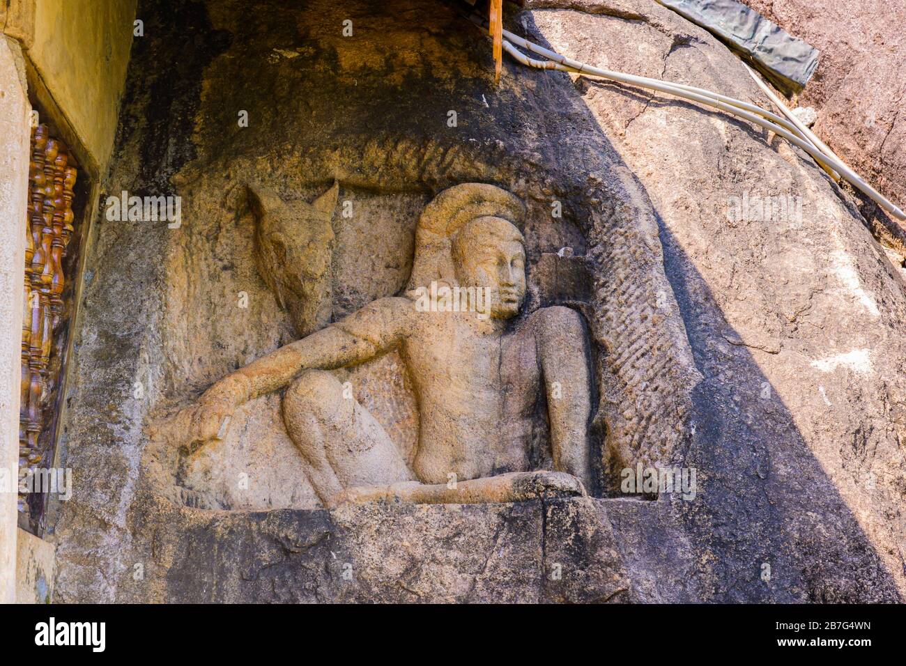 Sri Lanka Anuradhapura Isurumuni Rock Temple Monastery 3 BC built King Devanampiya Tissa sacred shrine stone carved into rock sculpture seated figure Stock Photo