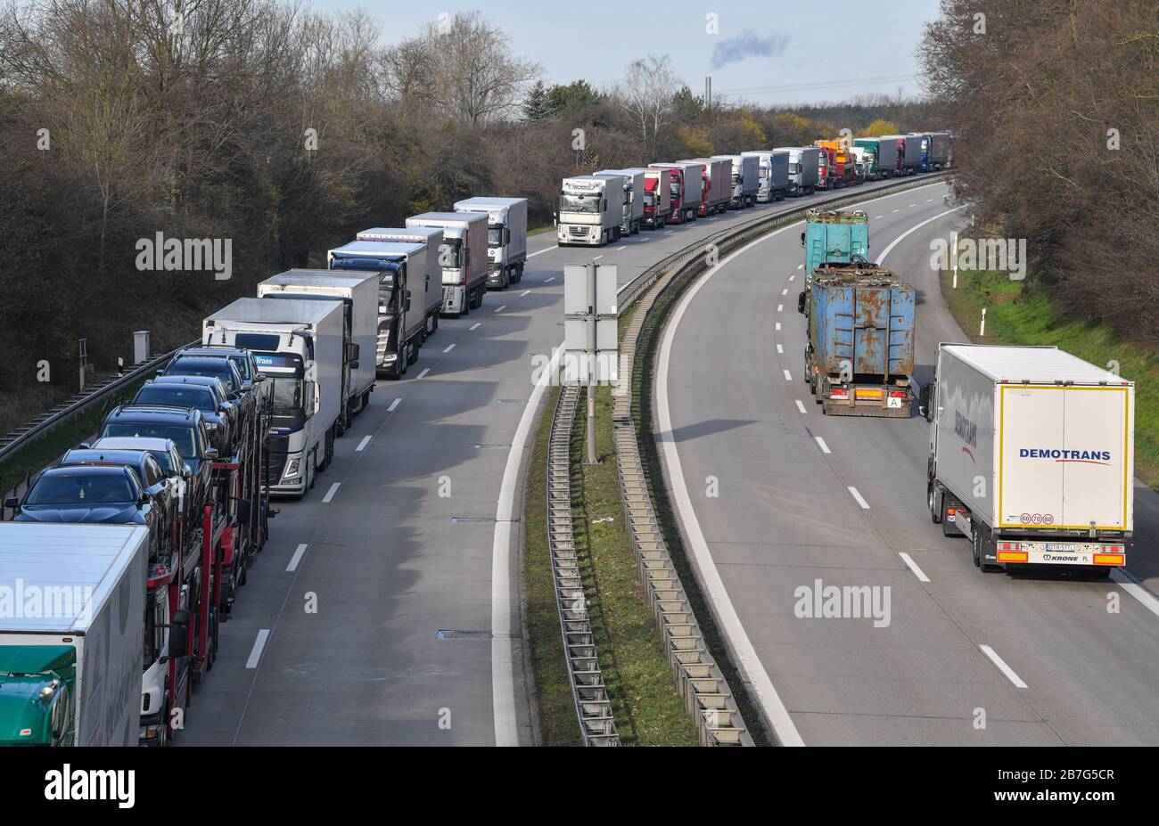 16 March 2020, Brandenburg, Frankfurt (Oder): Trucks are piling up on  Autobahn 12 in front of the German-Polish border crossing. Poland has  closed its borders to all foreigners since Sunday morning because