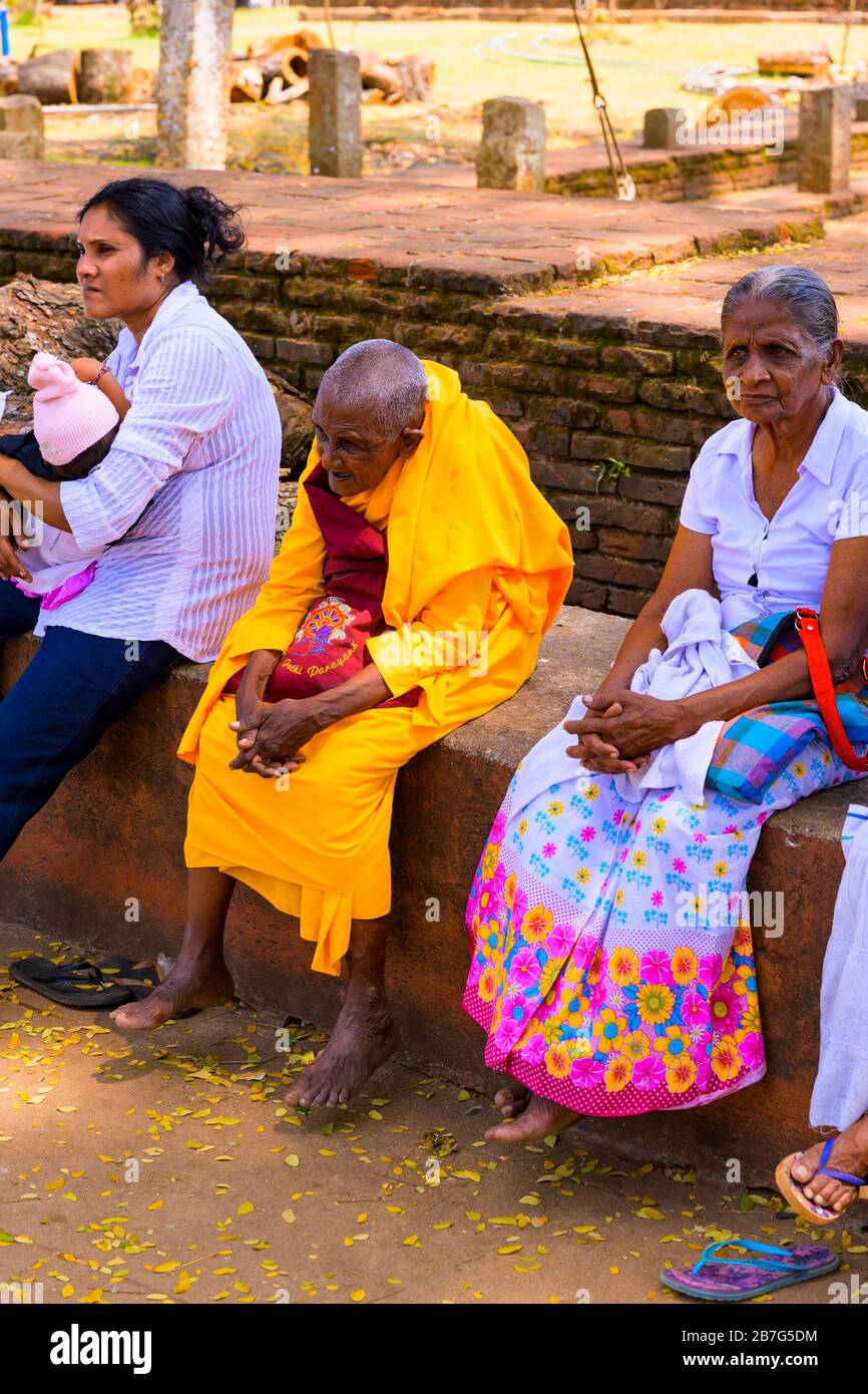 Sri Lanka Ceylon Cultural Triangle Anuradhapura Mahaseya Dagoba stupe pagoda complex Buddhist monk red orange robes habit Stock Photo
