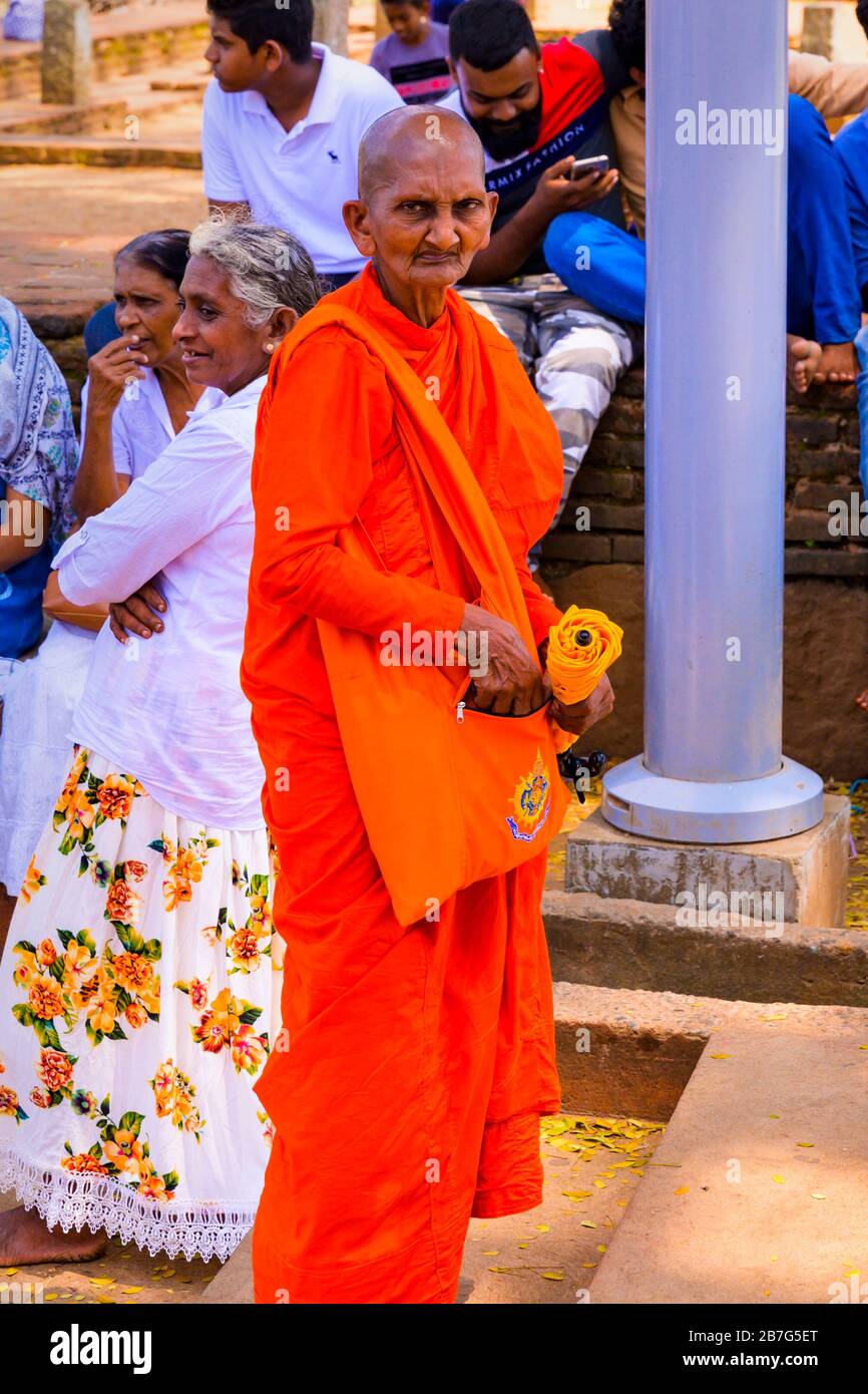 Sri Lanka Ceylon Cultural Triangle Anuradhapura Mahaseya Dagoba stupe pagoda complex Buddhist monk red orange robes habit Stock Photo