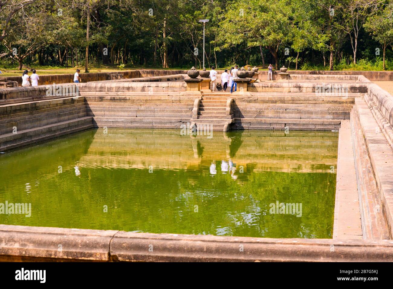 Sri Lanka Ceylon Cultural Triangle Anuradhapura Kuttan Pokuna twin ponds water steps stairs 8th century ritual baths tourists Stock Photo