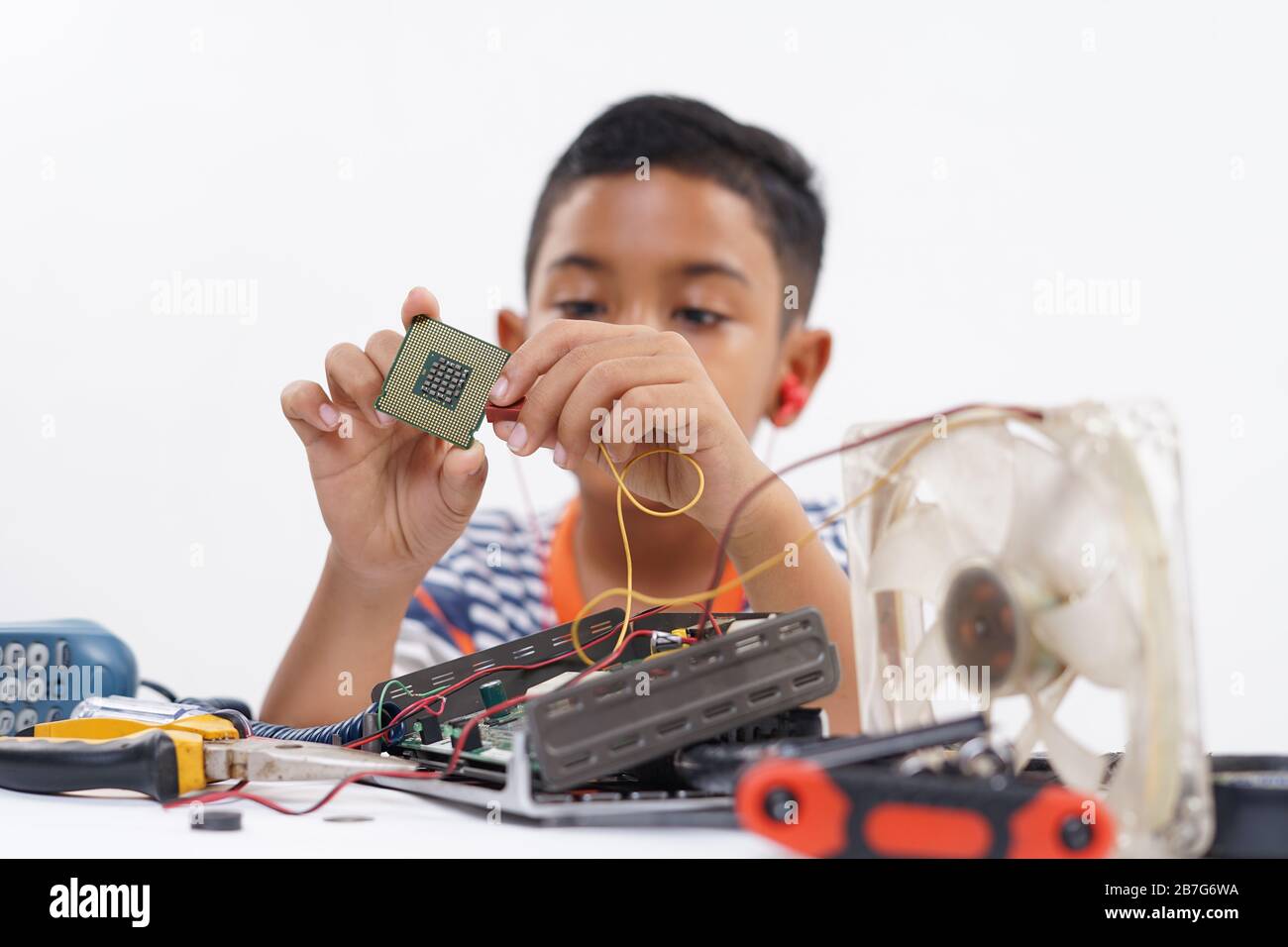 Boy holding processor for identify and repairing computer motherboard ...