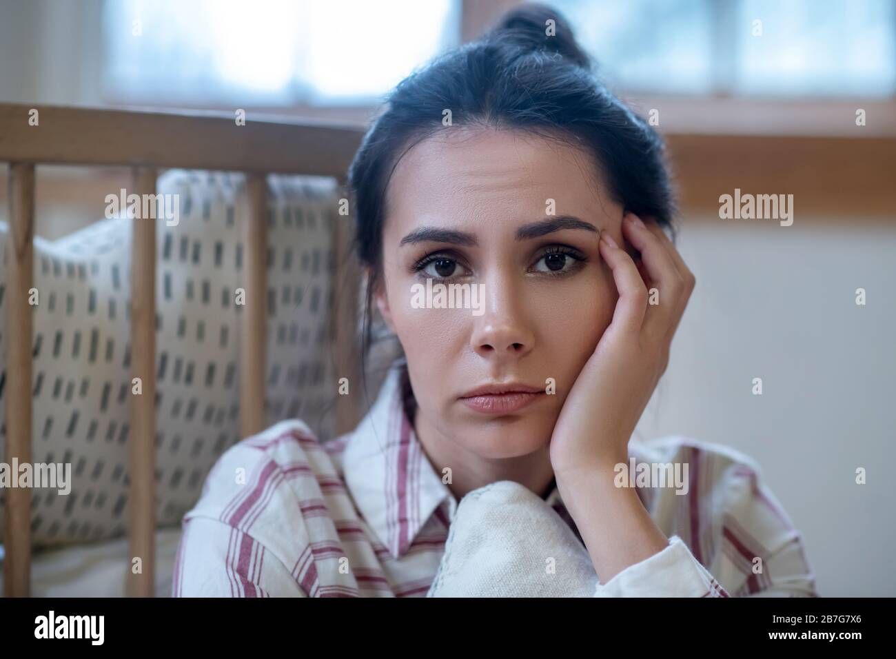 Sad young woman propping up her head Stock Photo Alamy