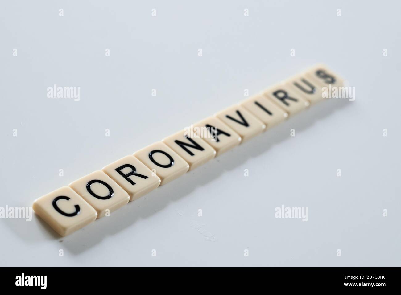 Coronavirus covid-19 spelt on scrabble tiles on white background Stock Photo
