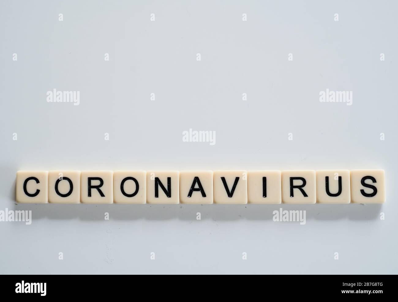 Coronavirus covid19 spelt on tiles with copy space above  Stock Photo