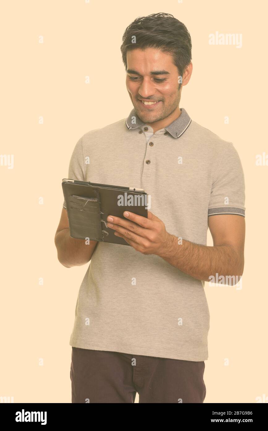 Young happy Persian man using digital tablet Stock Photo