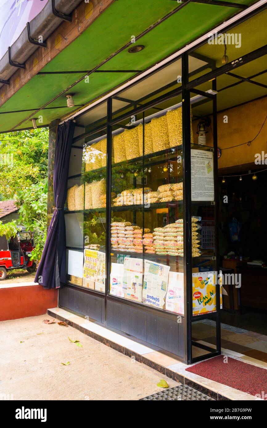 South Asia Sri Lanka local grown nut nuts plastic bags of cashews shop store snacks door entrance window windows Anacardium Occidentale Stock Photo