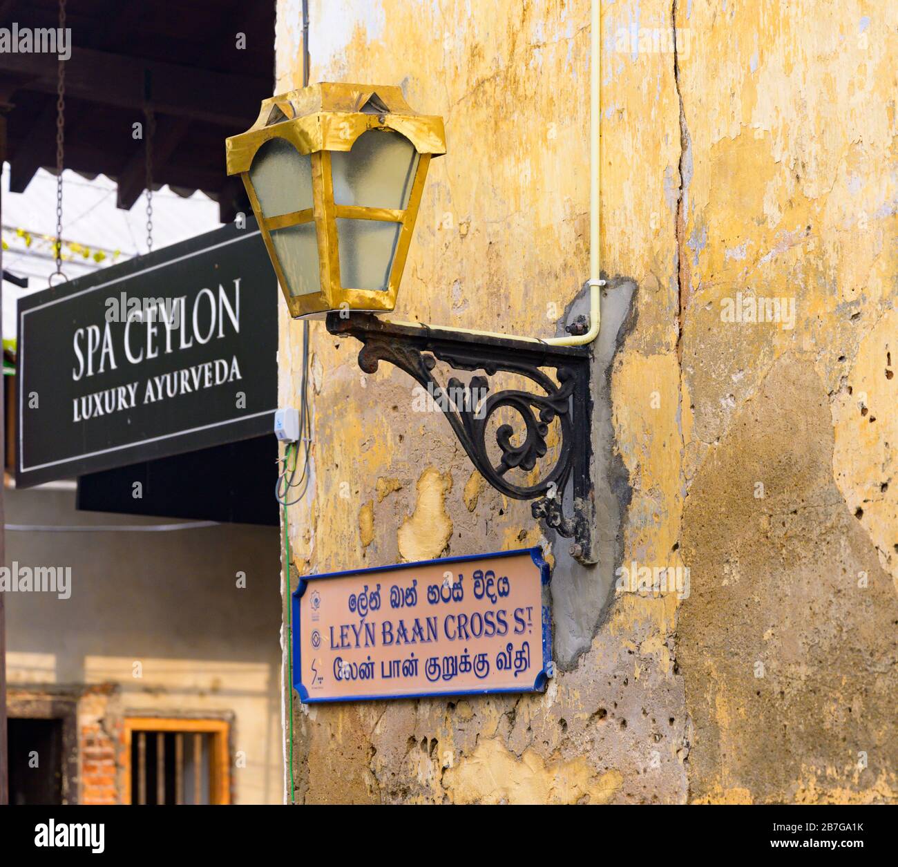 South Asia Sri Lanka Fort Galle colonial town centre old ancient harbour port street scene light Leyn Baan Cross St sign script Spa Ceylon shop signs Stock Photo