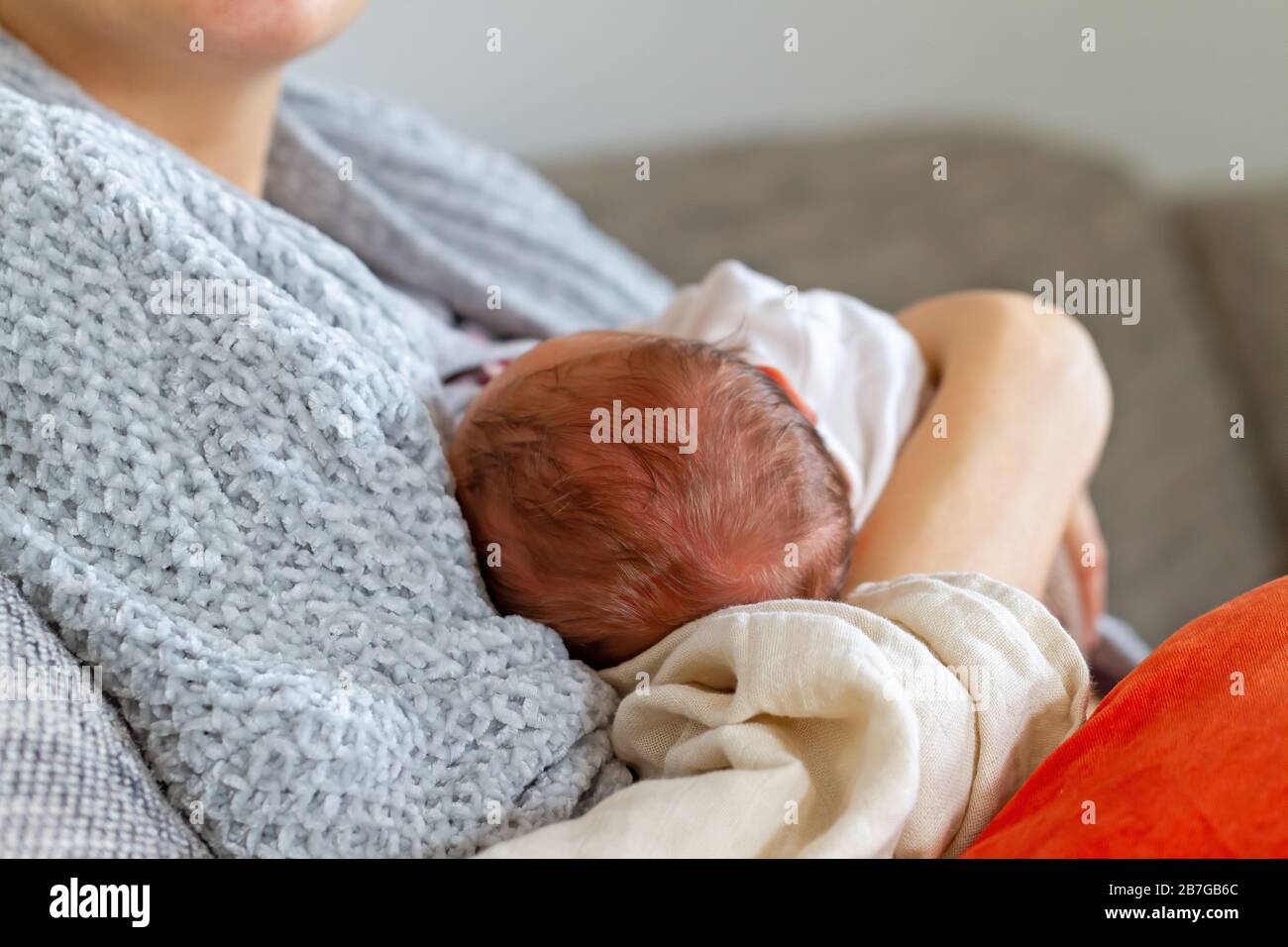Mother holding her newborn Stock Photo