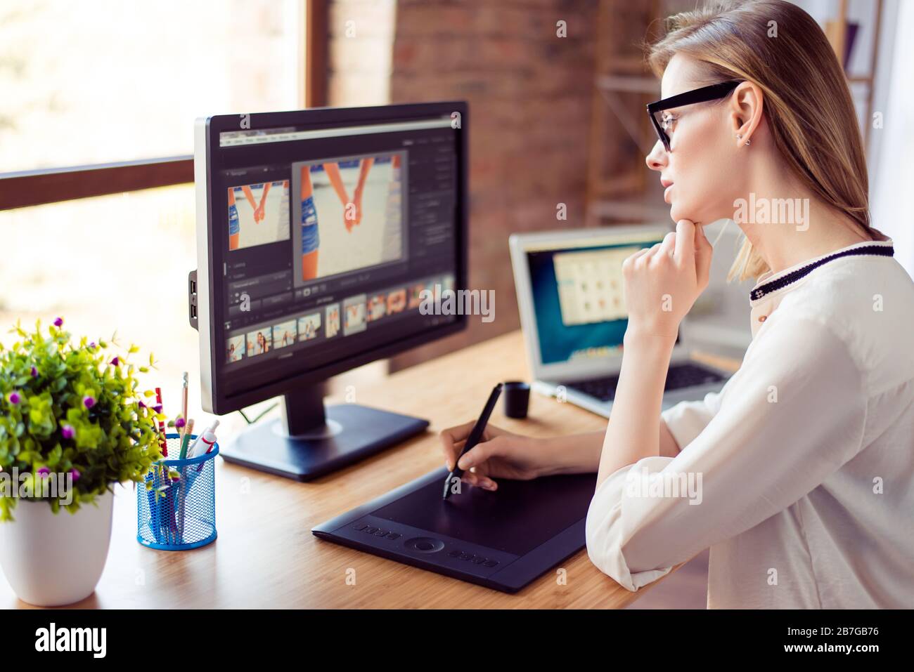 Side view of graphic designer working with interactive pen display ...