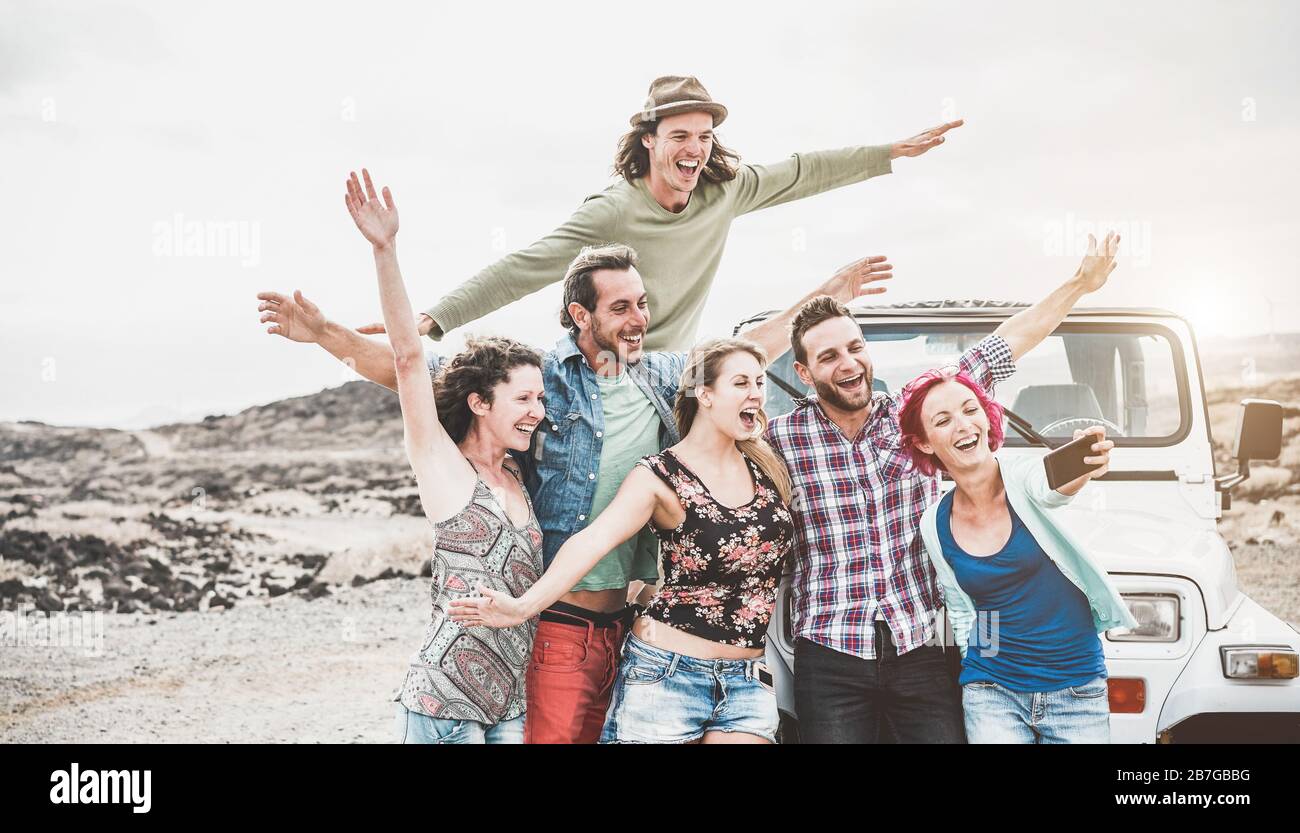 Happy friends making story for social network app around desert - Young ...
