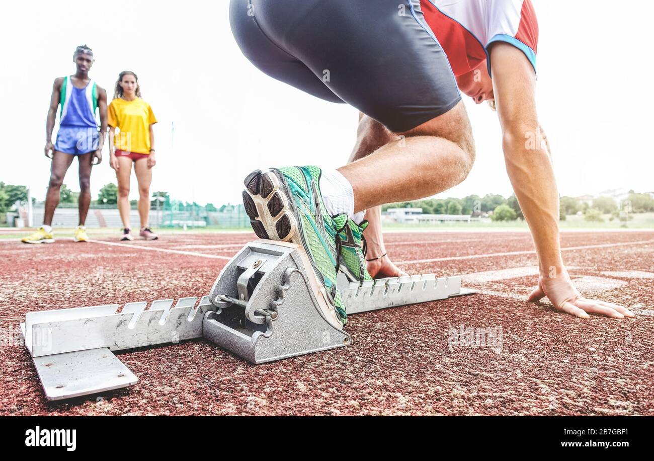 Runner using starting block to start his run on race track - Young ...