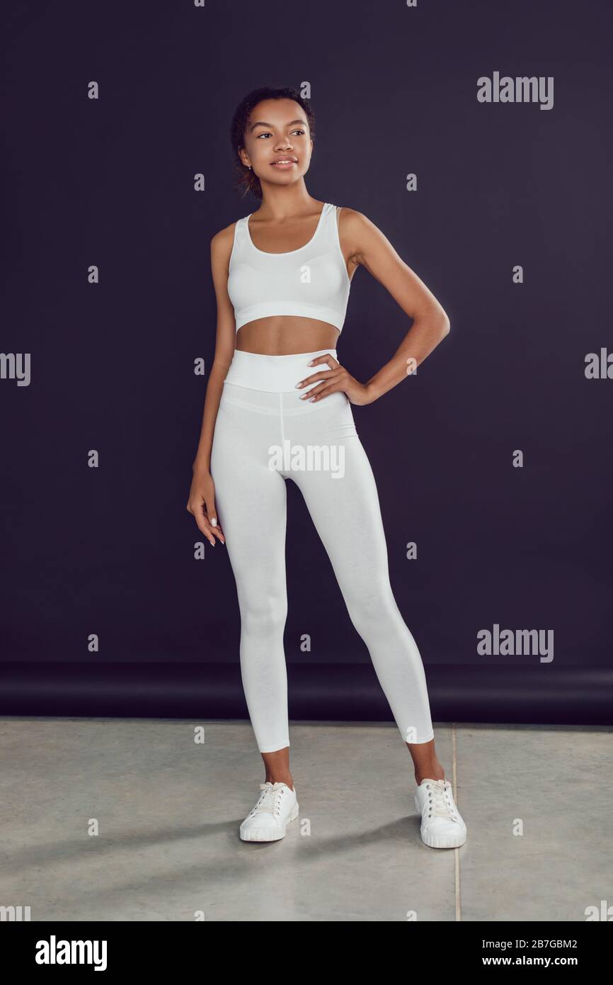 Young african american woman in white blank leggings and a crop top.  Mock-up Stock Photo - Alamy