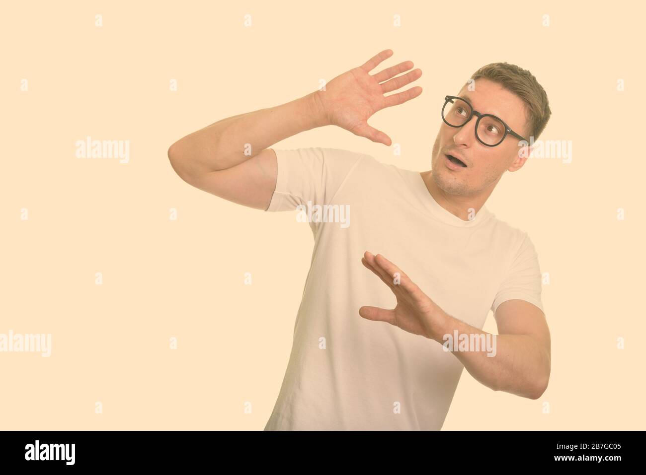 Portrait of stressed nerd man with eyeglasses looking scared Stock Photo