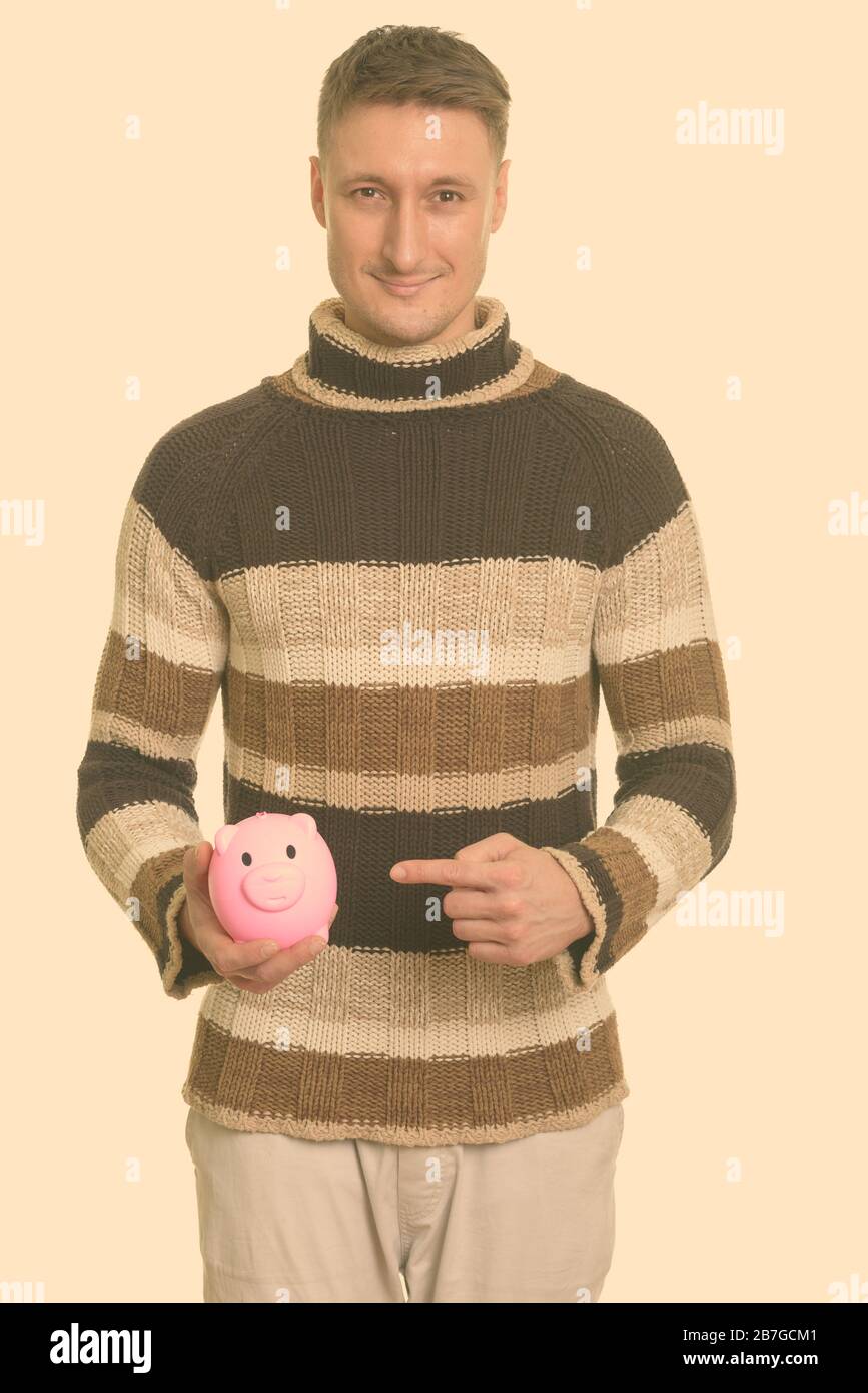 Portrait of handsome man with piggy bank Stock Photo - Alamy