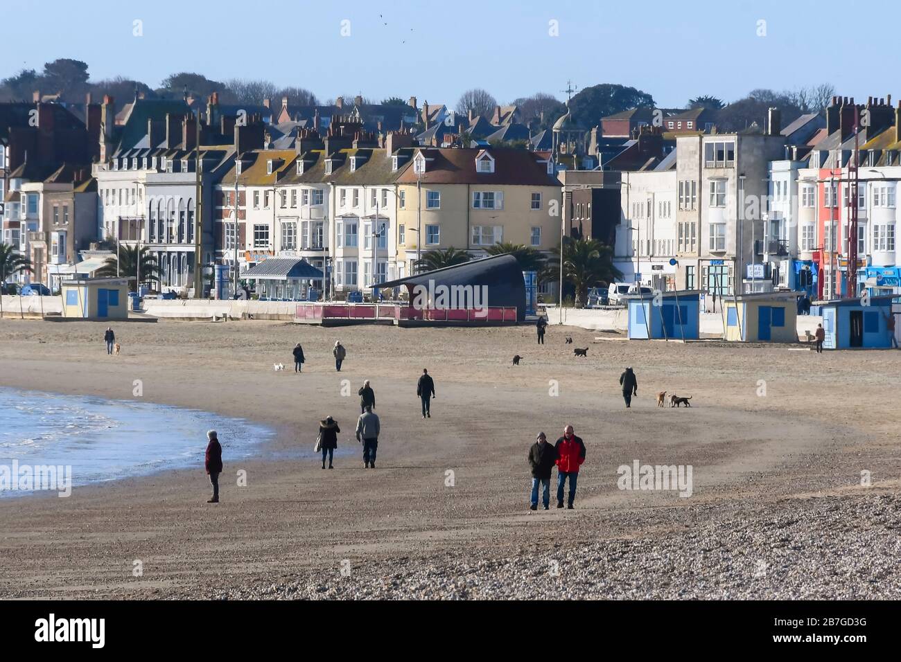 Weymouth, Dorset, UK. 16th March 2020. UK Weather. Dog walkers and