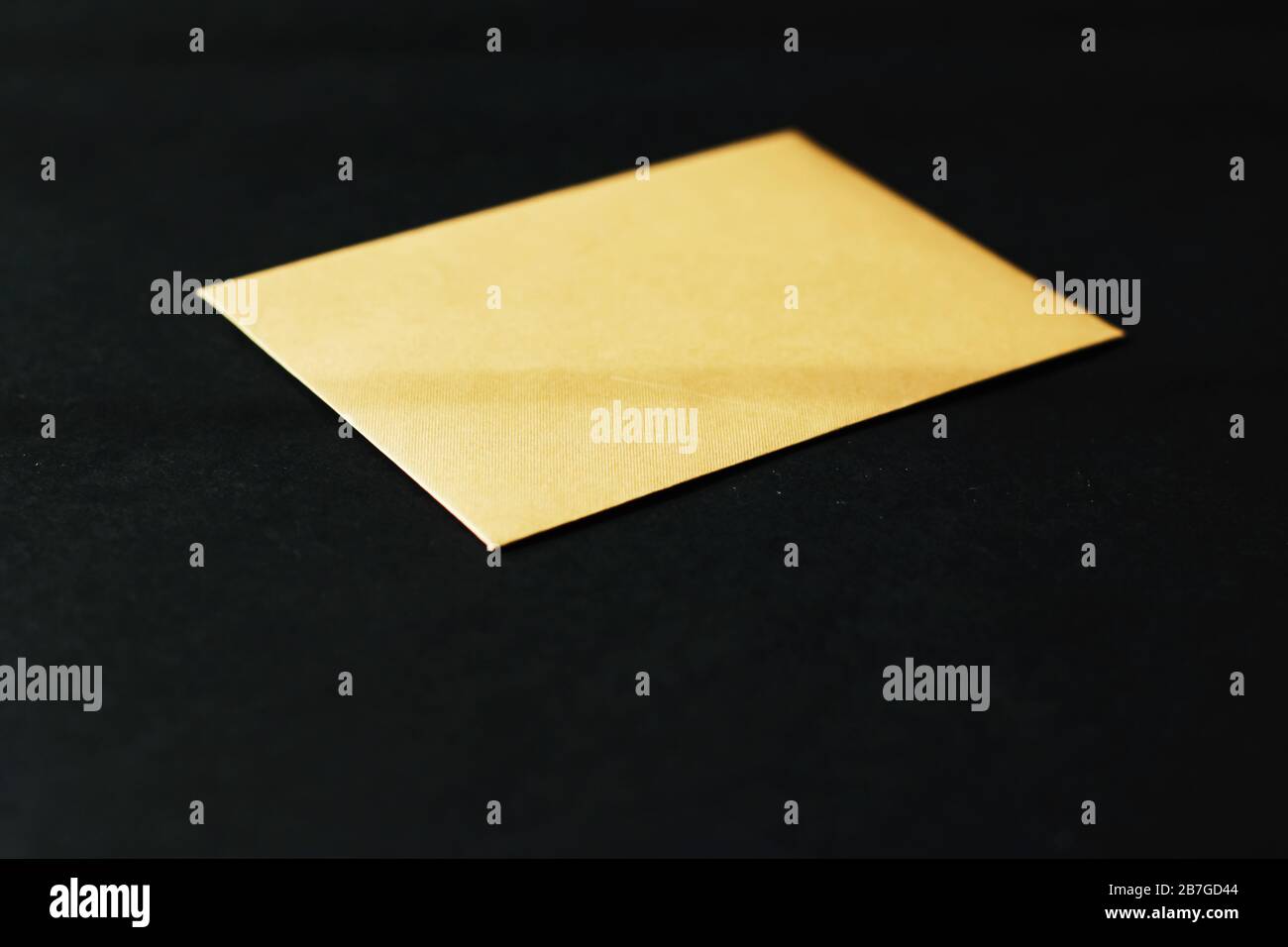 Blank golden paper card on black background, premium business and ...