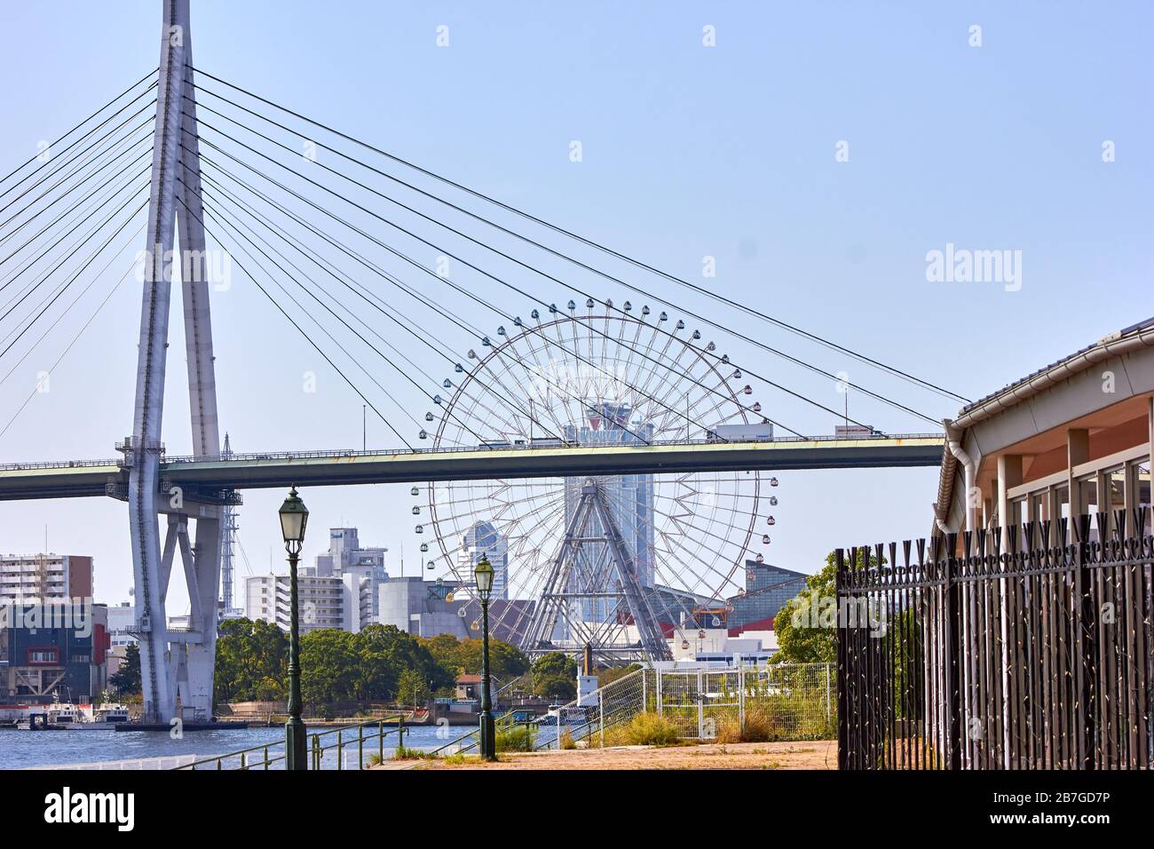 Brifge over the river with ferris wheel in the background Stock Photo