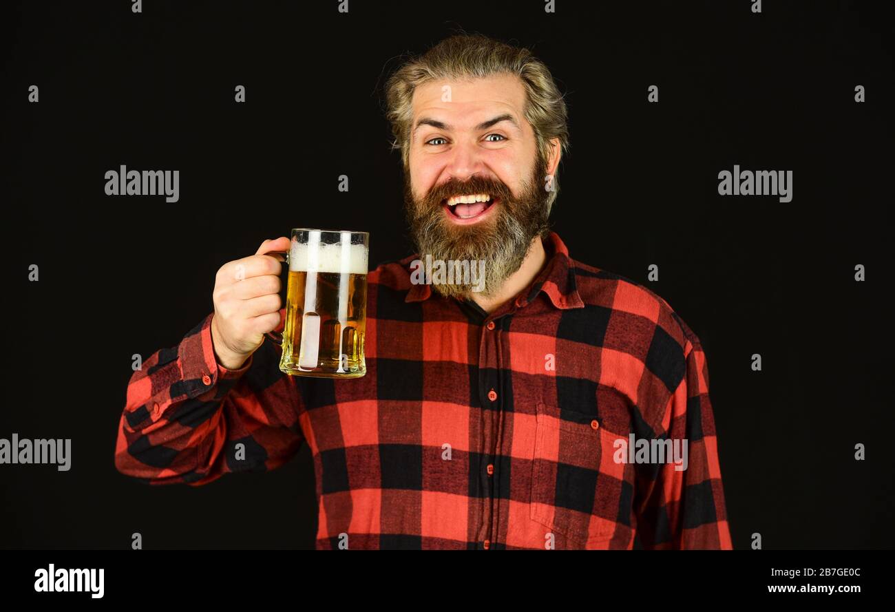 Controlling beer quality. Brutal bearded male drinks beer from glass. Beer pub. bartender or barman in bar. recreation. Man hold glass of beer. hipster at bar counter. having fun watching football. Stock Photo