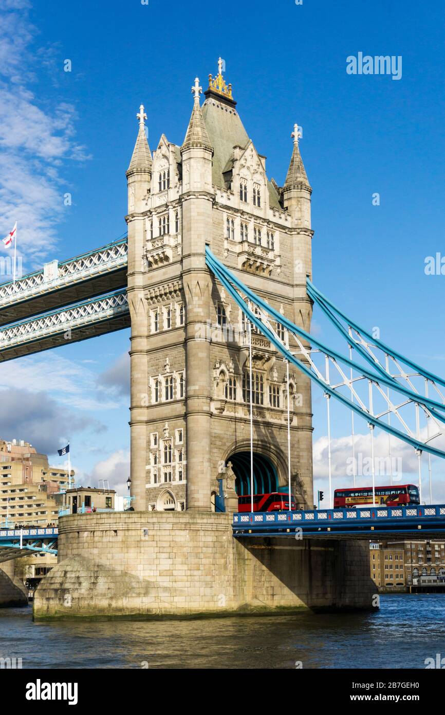 South side of Tower Bridge across the River Thames. Red london bus crossing bridge. Stock Photo